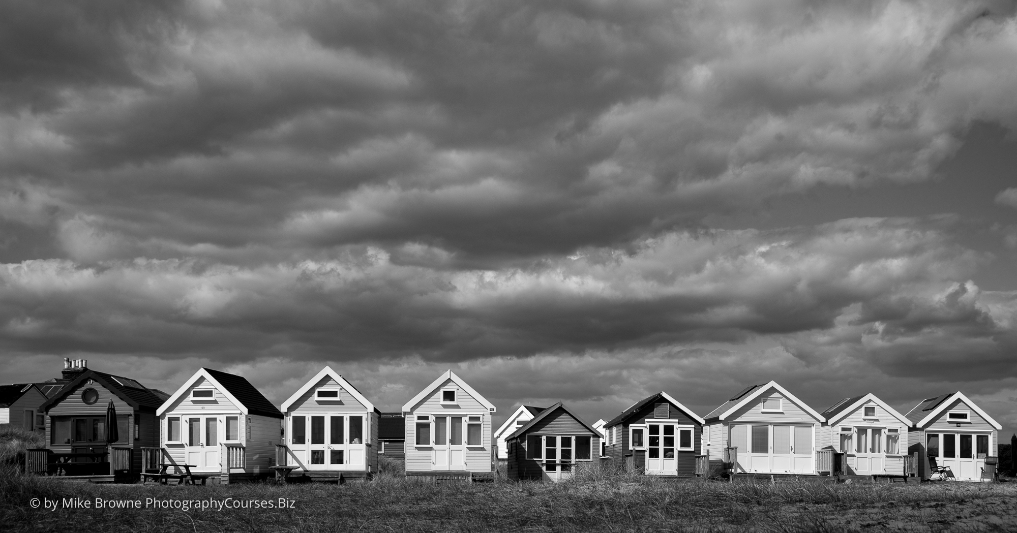 Row of beach huts at Hengistbury head on a cloud day in Dorset
