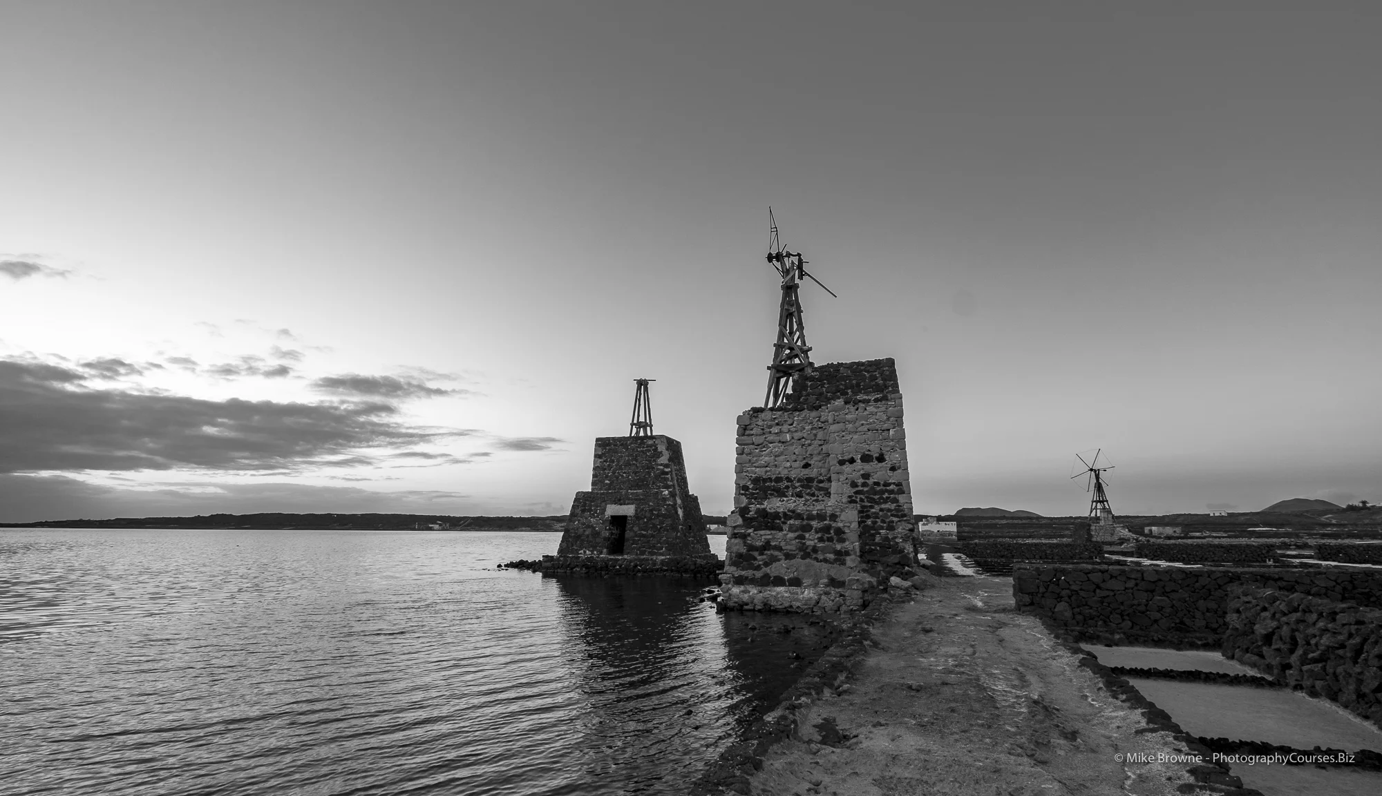 Abandoned windmills deteriorating by the sea