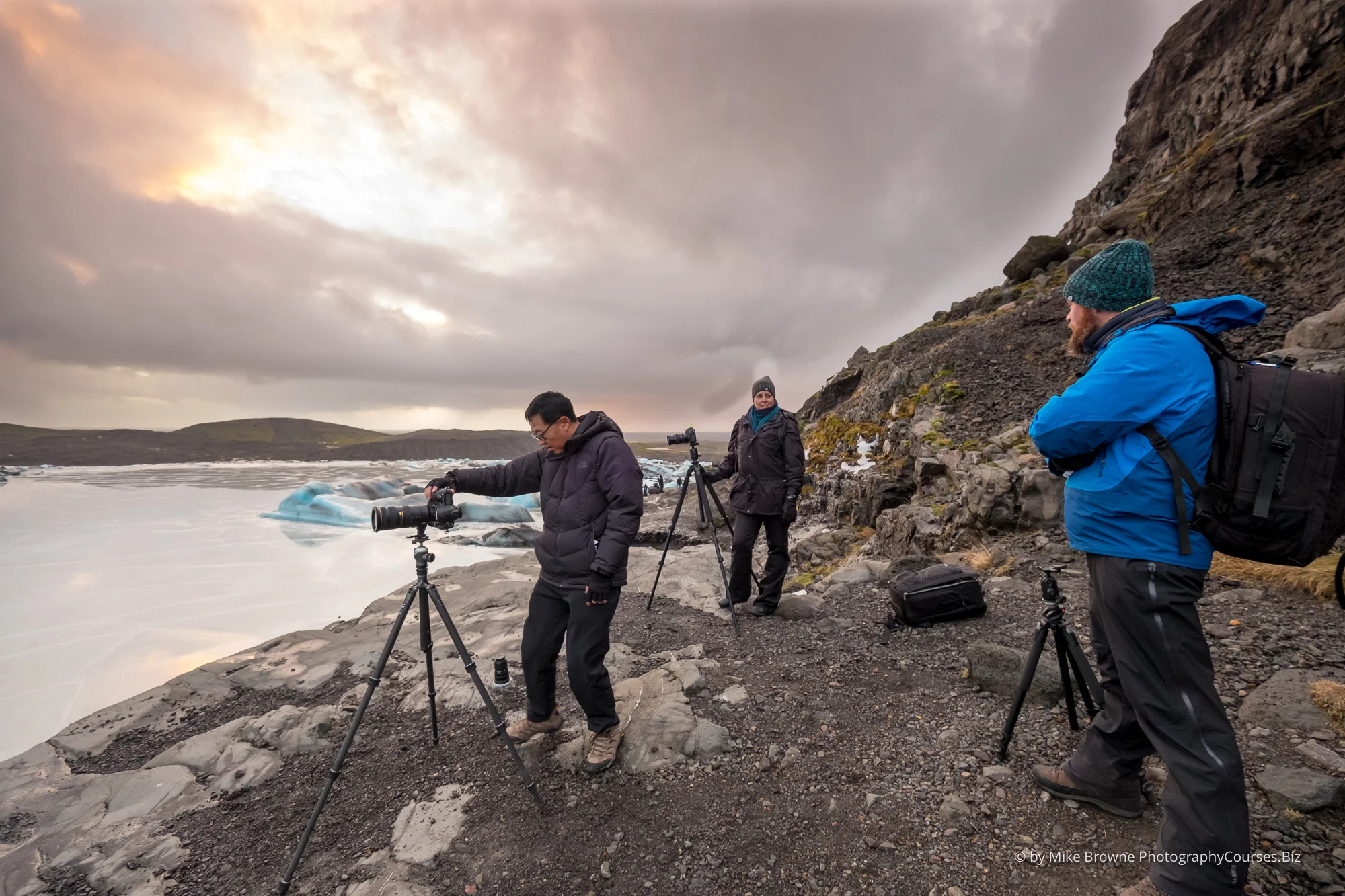 Three photographers photographing an ice lagoon in Iceland