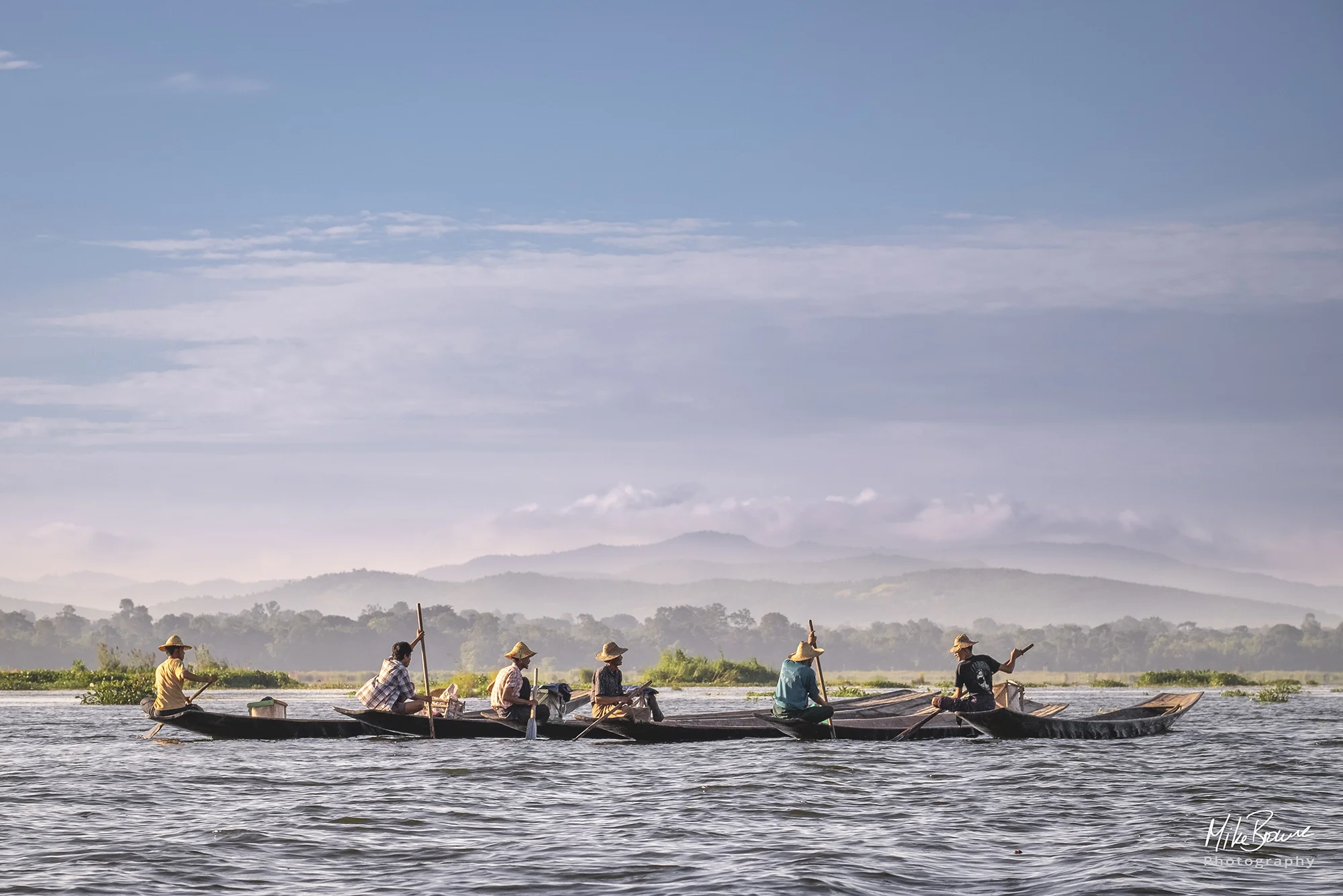 Five fishermen on their boats on Inle Lake, Myanmar