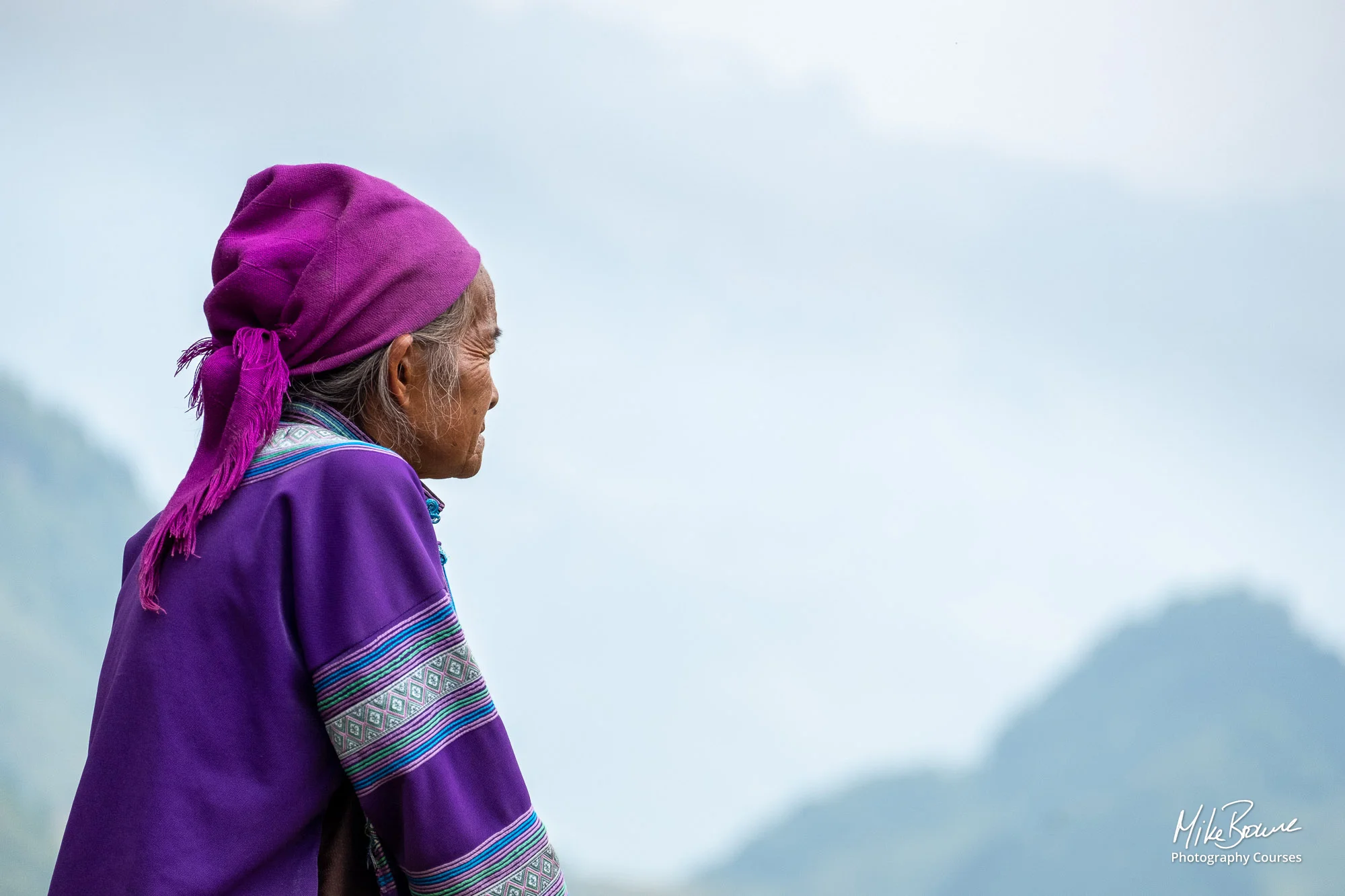 Old woman contemplating distant mountains in North Vietnam