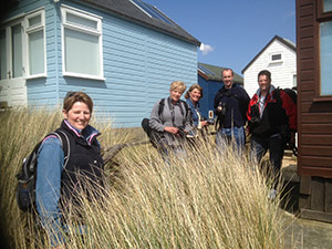 Five people pose for a Mudeford photography workshop group shot
