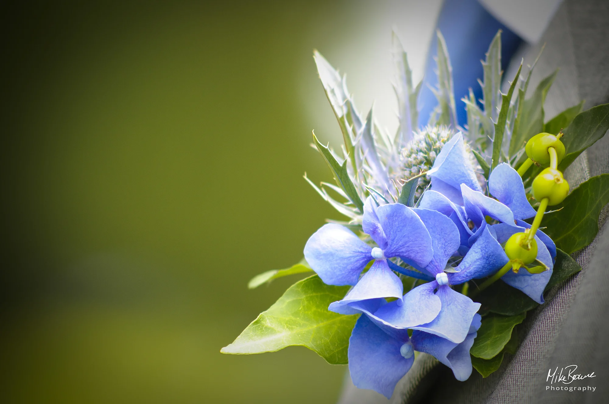 Blue flowers and leaves of a Groomsman\'s boutonniere