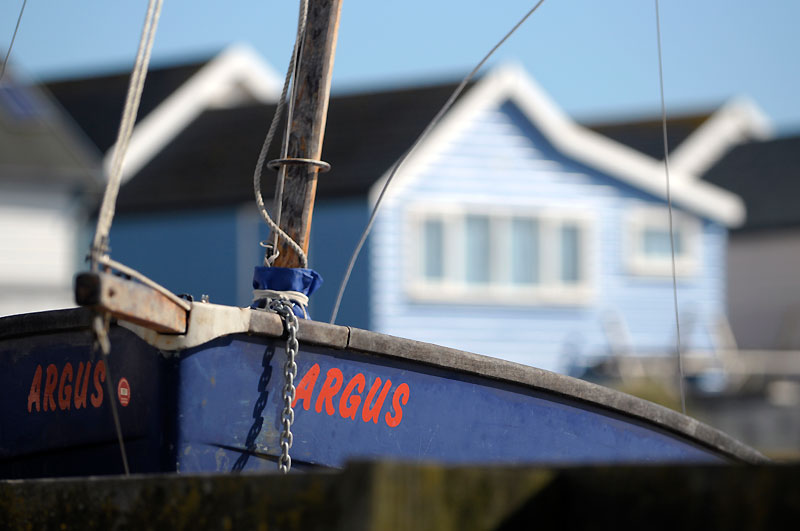 Bow of blue boat with ARGUS written in red