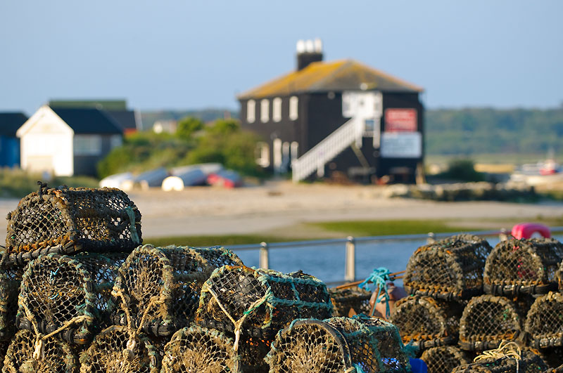 Lobster pots in front of The Black House at Mudeford Quay