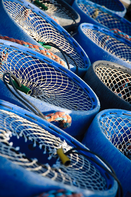 Close up of blue fishing containers with wired tops