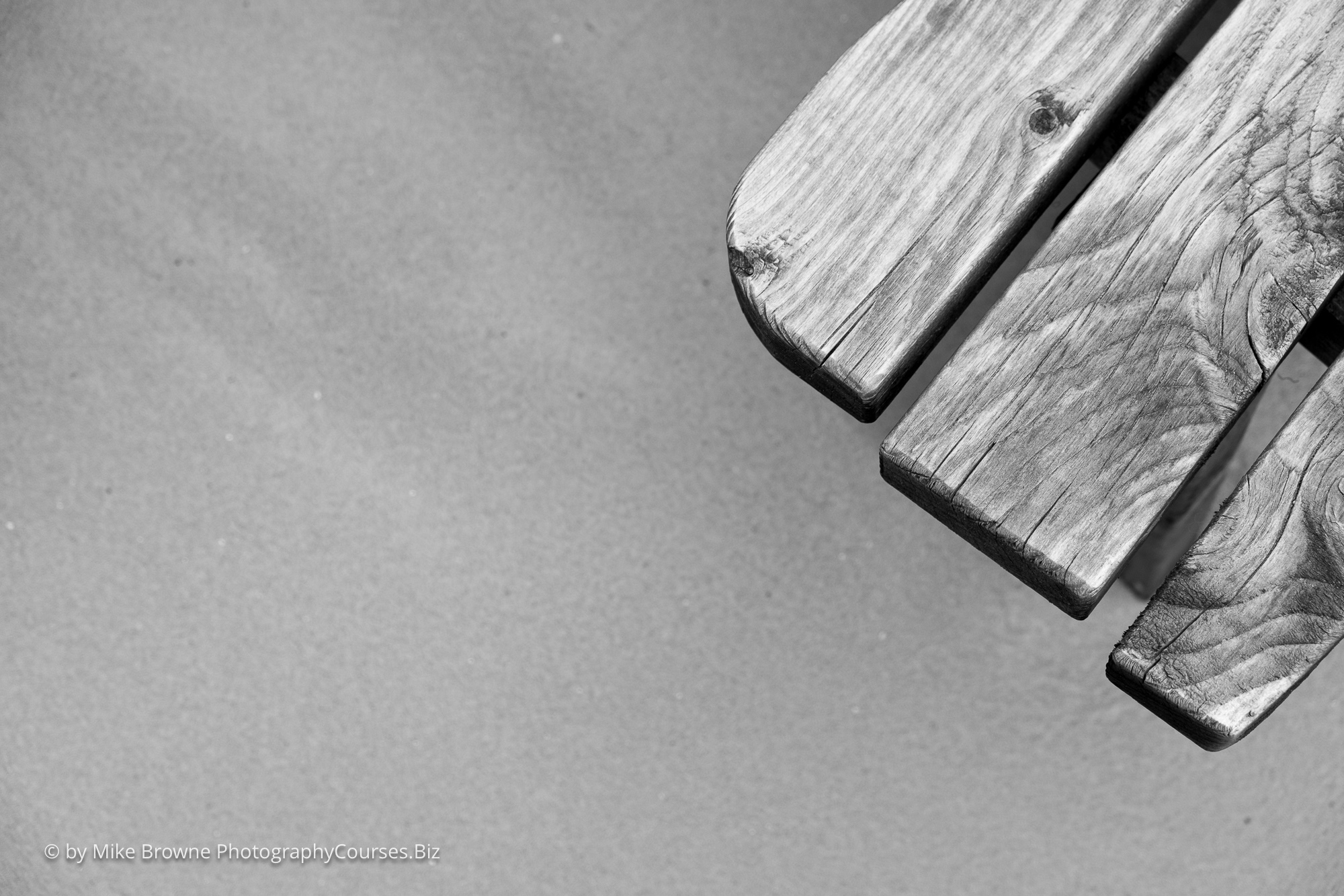 The edge of a wooden table showing the fine grain detail on three panels