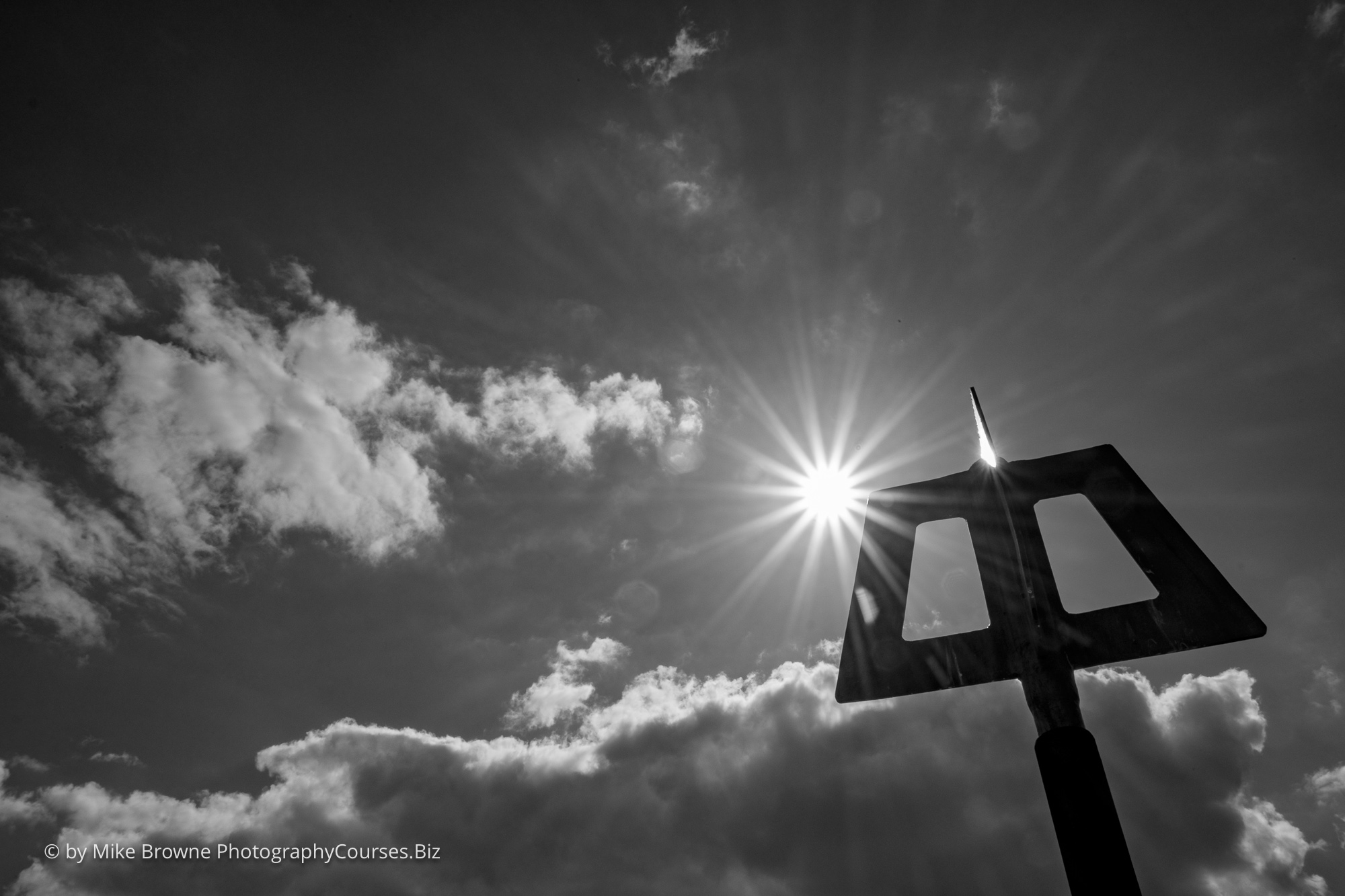 Looking directly into the sun with a silhouetted sign at Mudeford quay