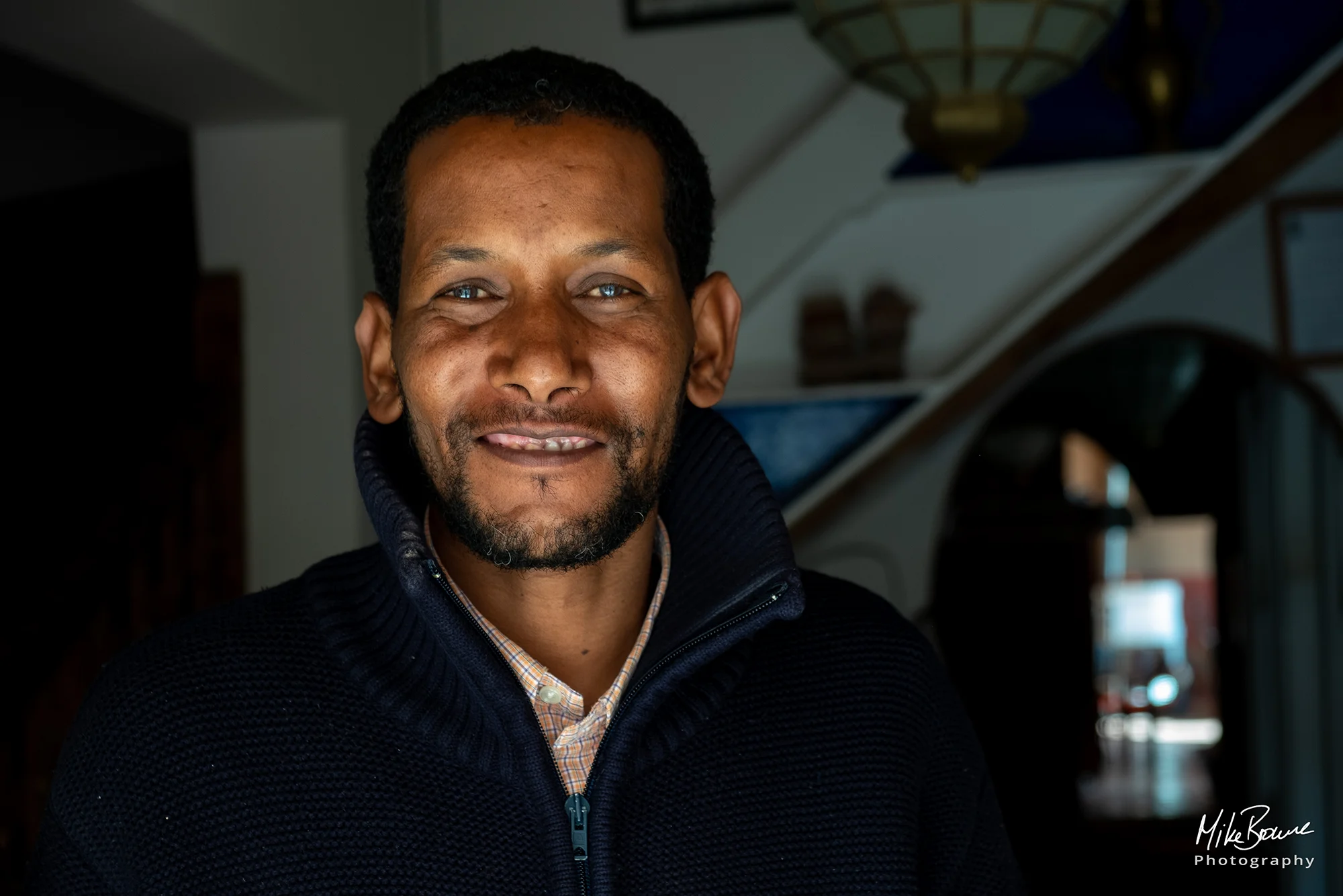 Moroccan man smiling in front room of his house in Ourika Valley, Morocco