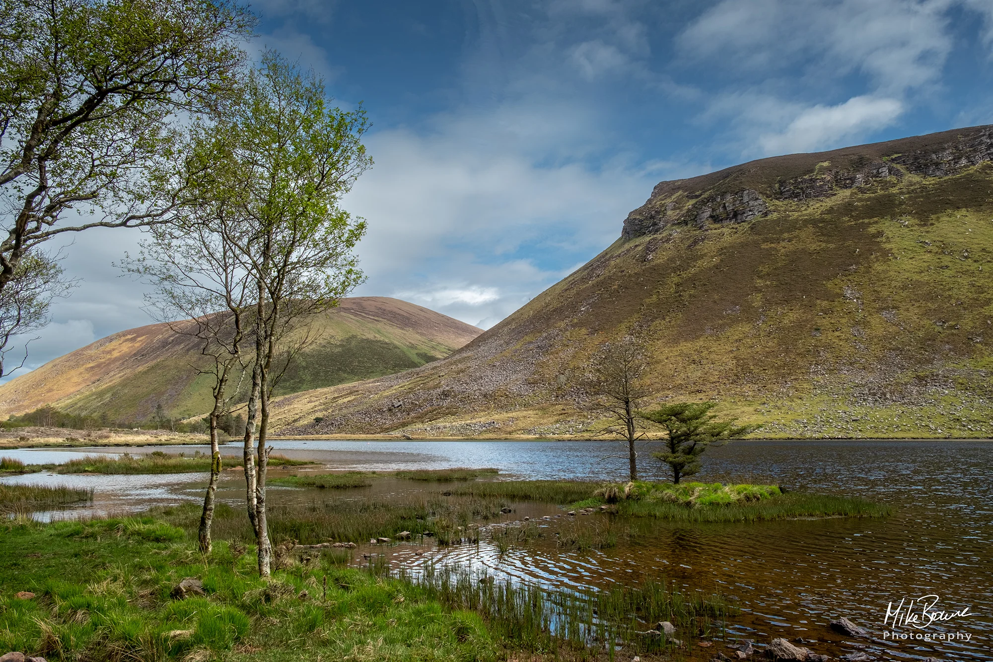 Lake surrounded by hills and trees