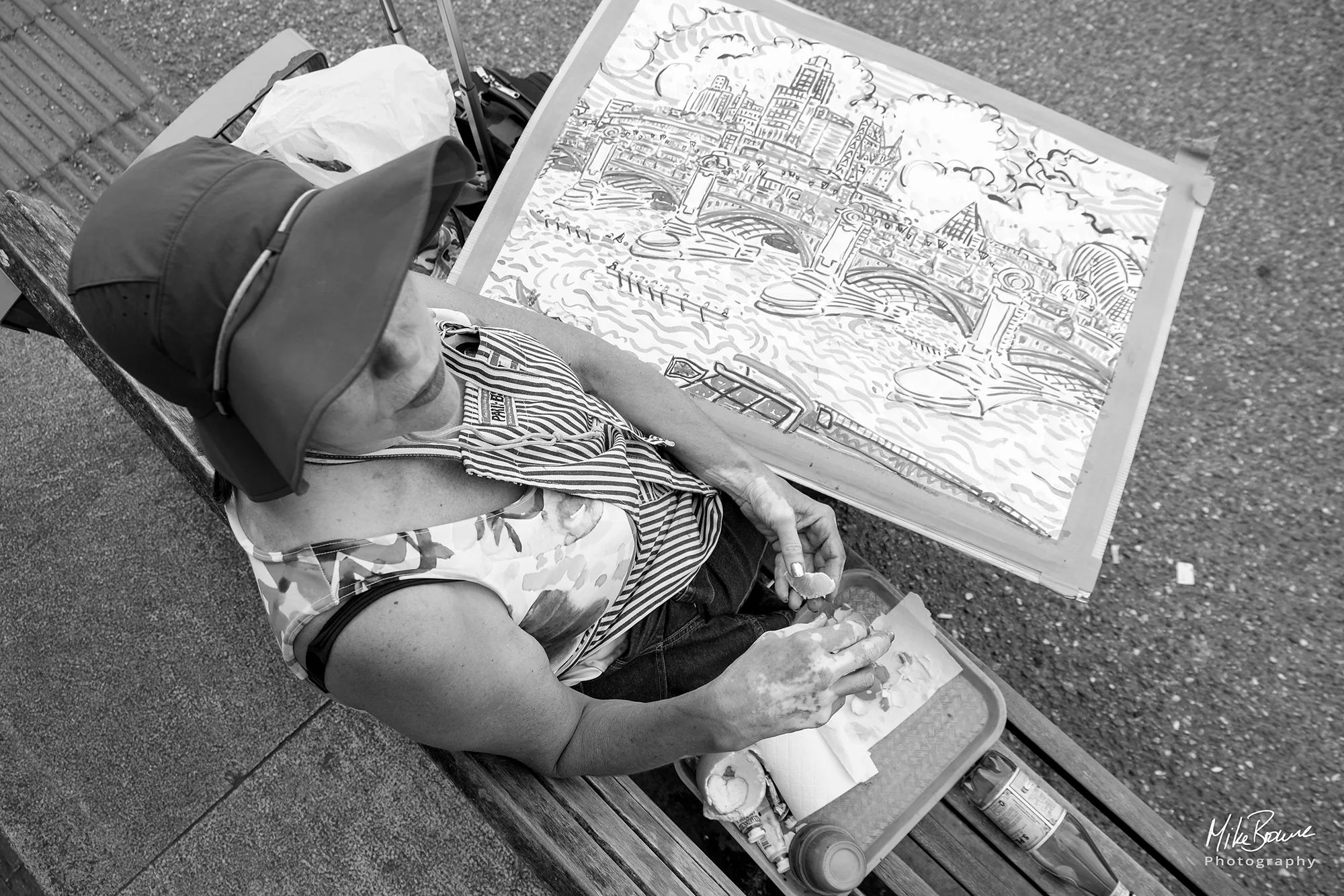 Female artist with her painting of Tower Bridge in London UK