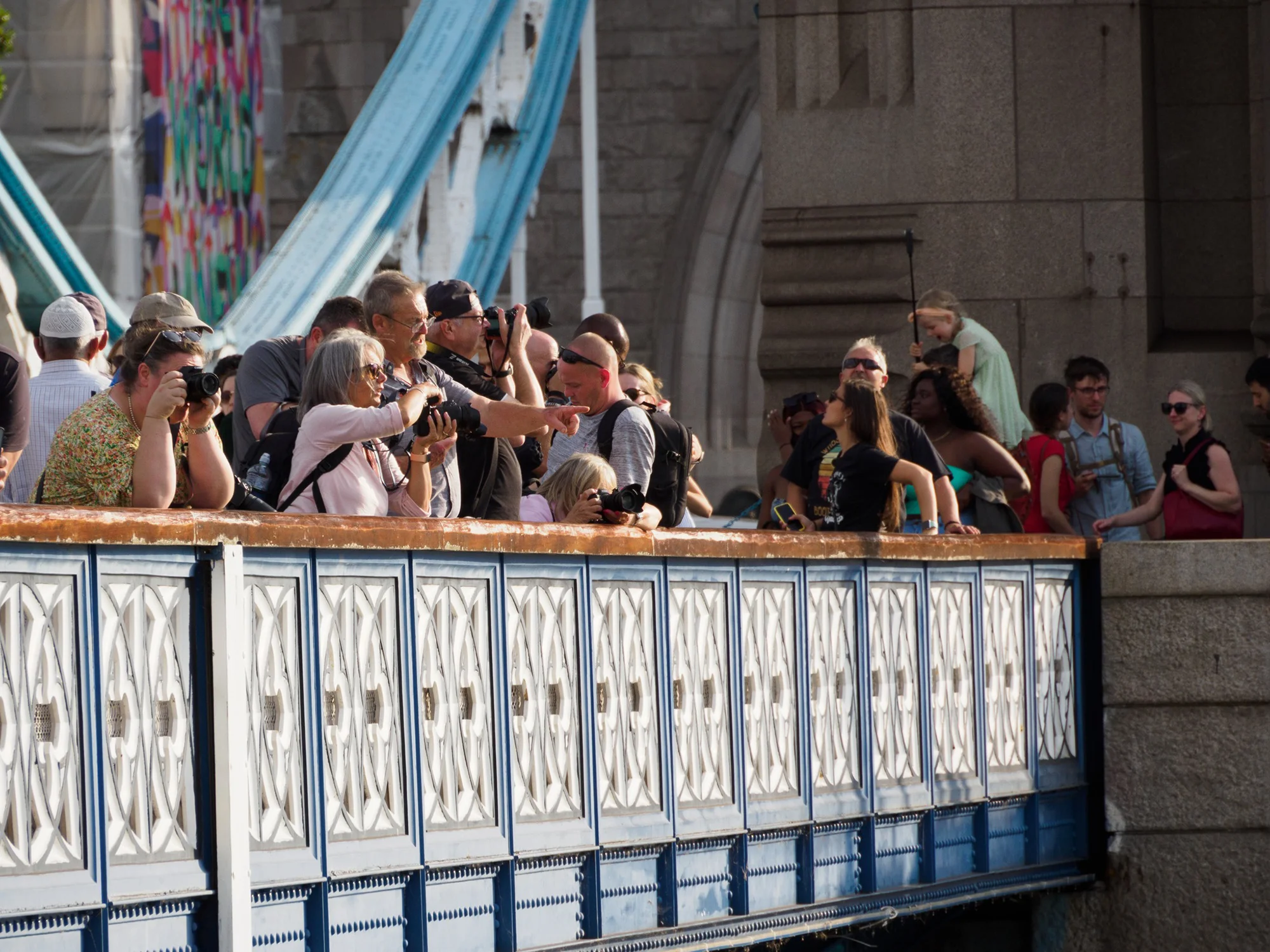 Photographer Mike Browne teaching students on Tower Bridge in Central London