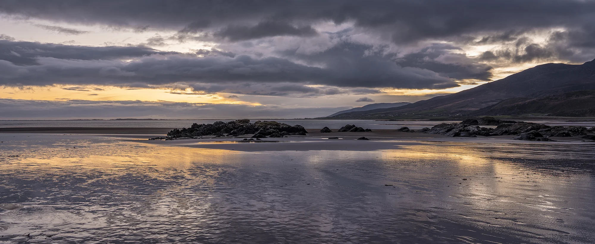 Reflection of sunrise at Cappagh beach in Ireland