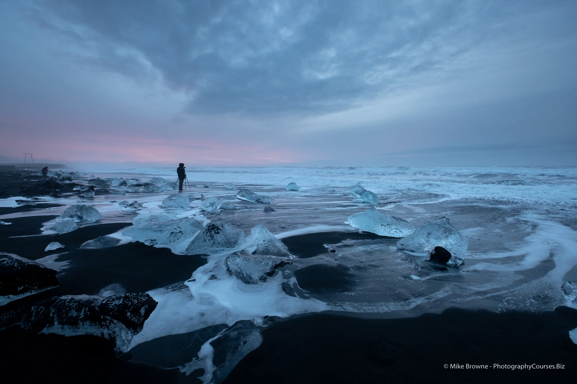 Lone photographer at sun rise on ice beach in vatnajokull national park