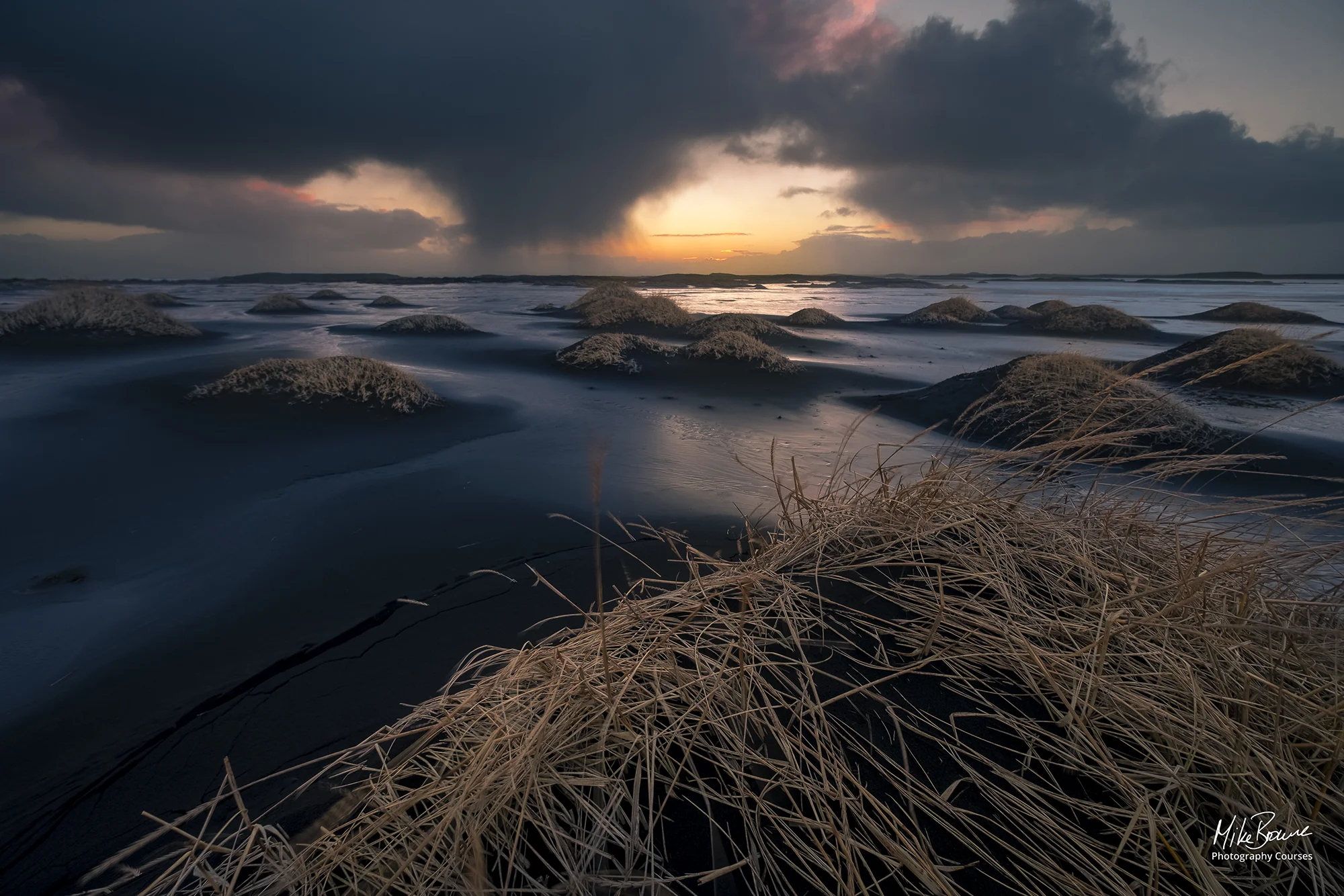 Black sand dunes in Stokksnes with approaching storm at sunset