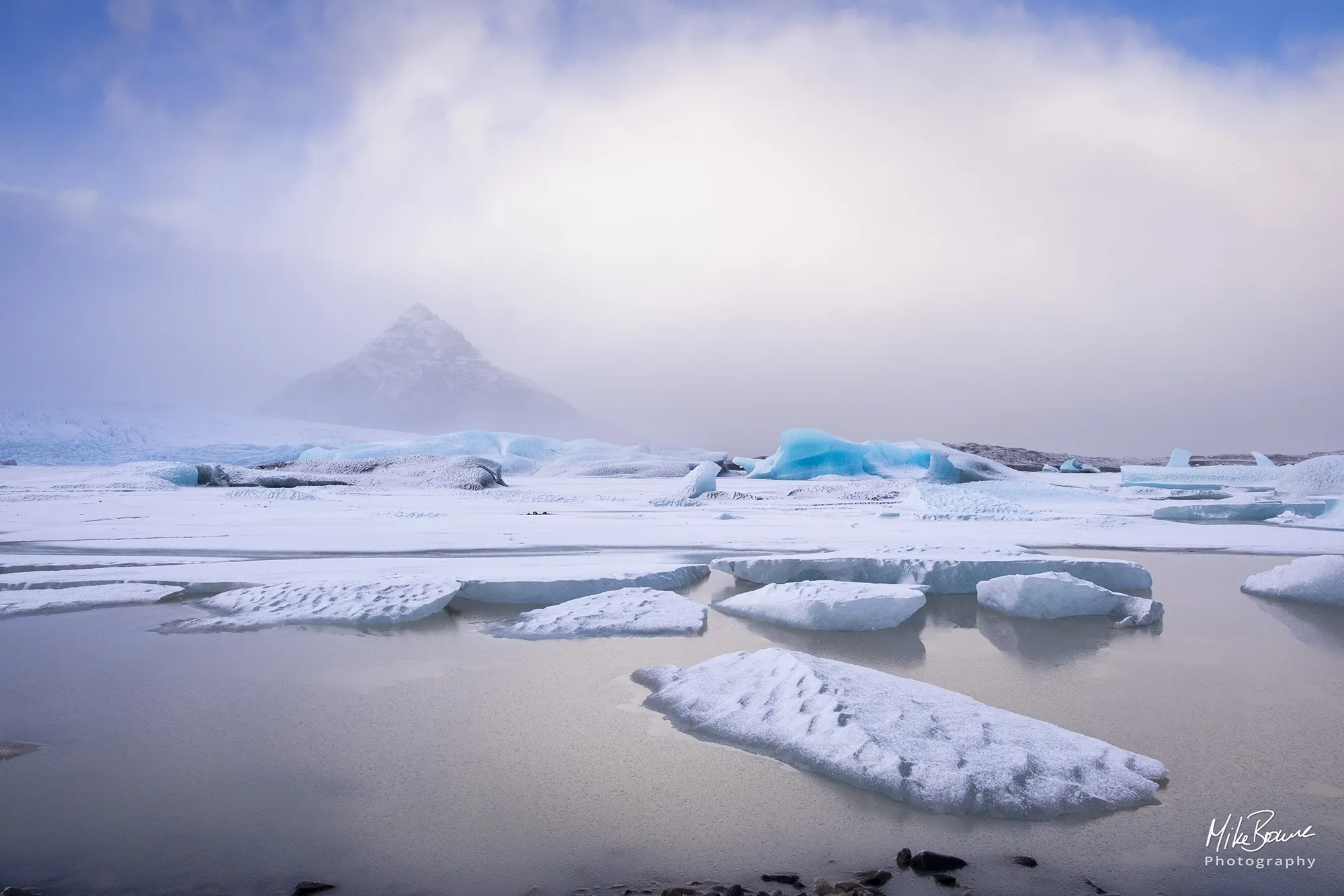 Ice lagoon and mountain with departing snow storm