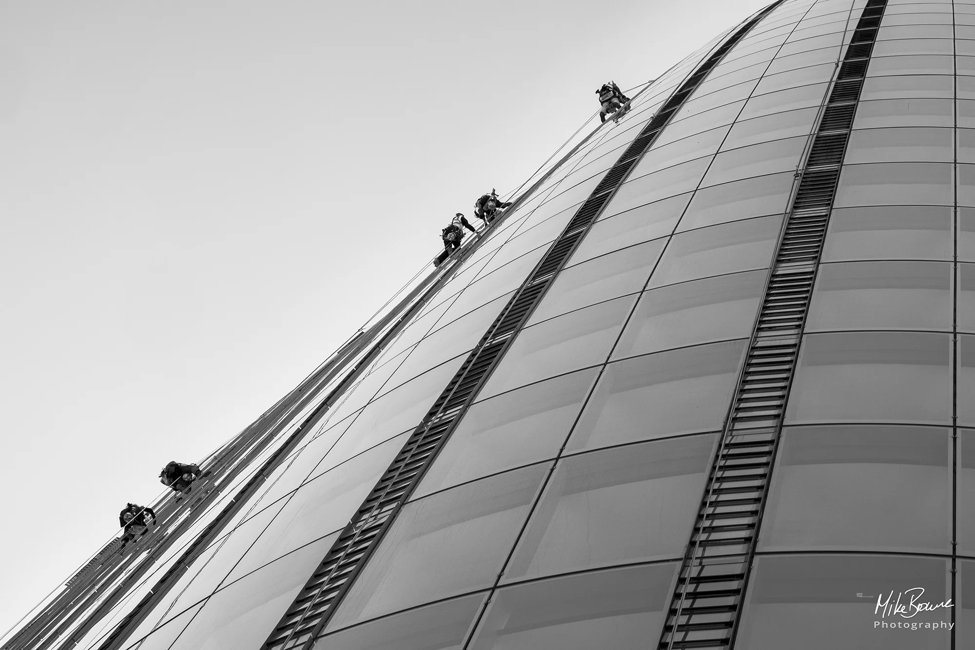 tint figures of workmen cleaning windows on a London skyscraper
