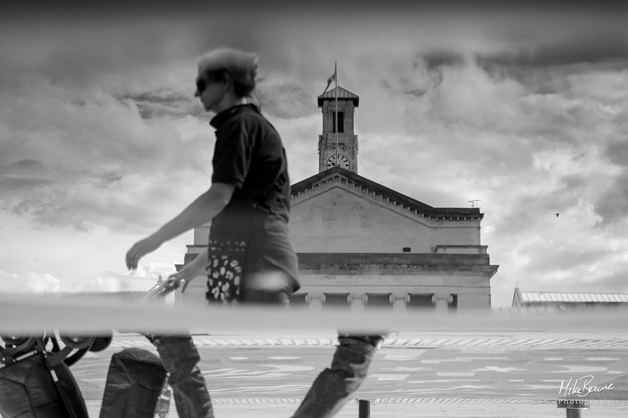 Strange reflection of woman, Southampton Guild Hall and a cloudy sky