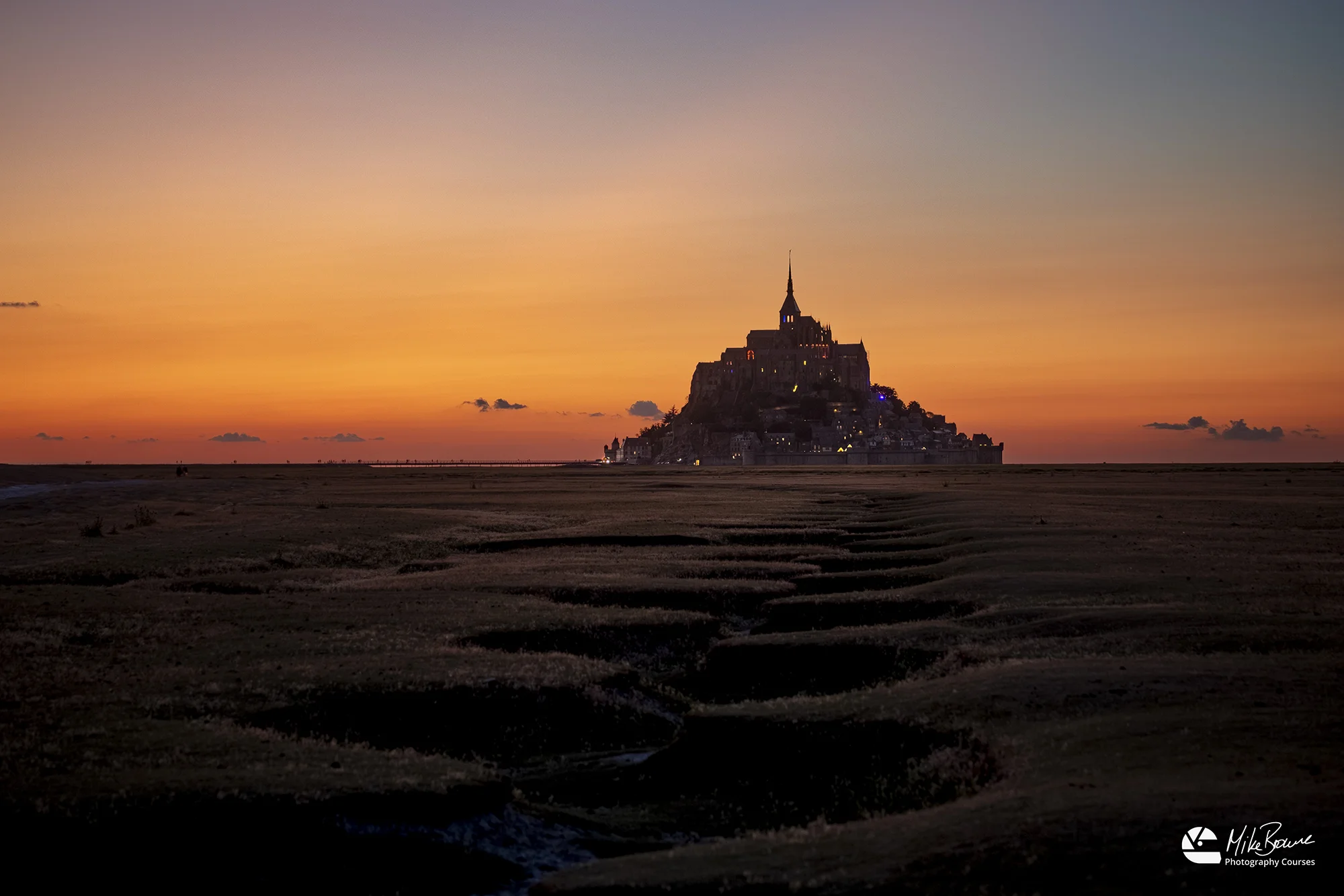 zig zag pattern leading over fields to Le Mont St Michel at sunset