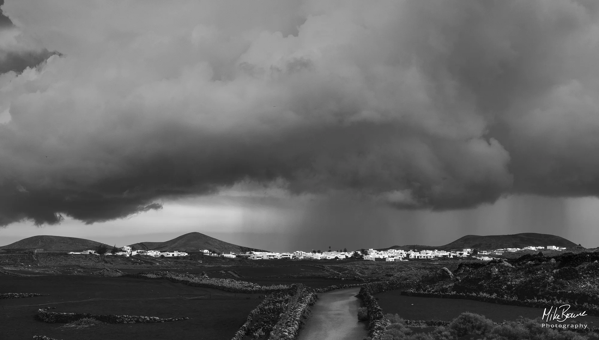 Rain storm above village of Mancha Blanca on Spanish island of Lanzarote
