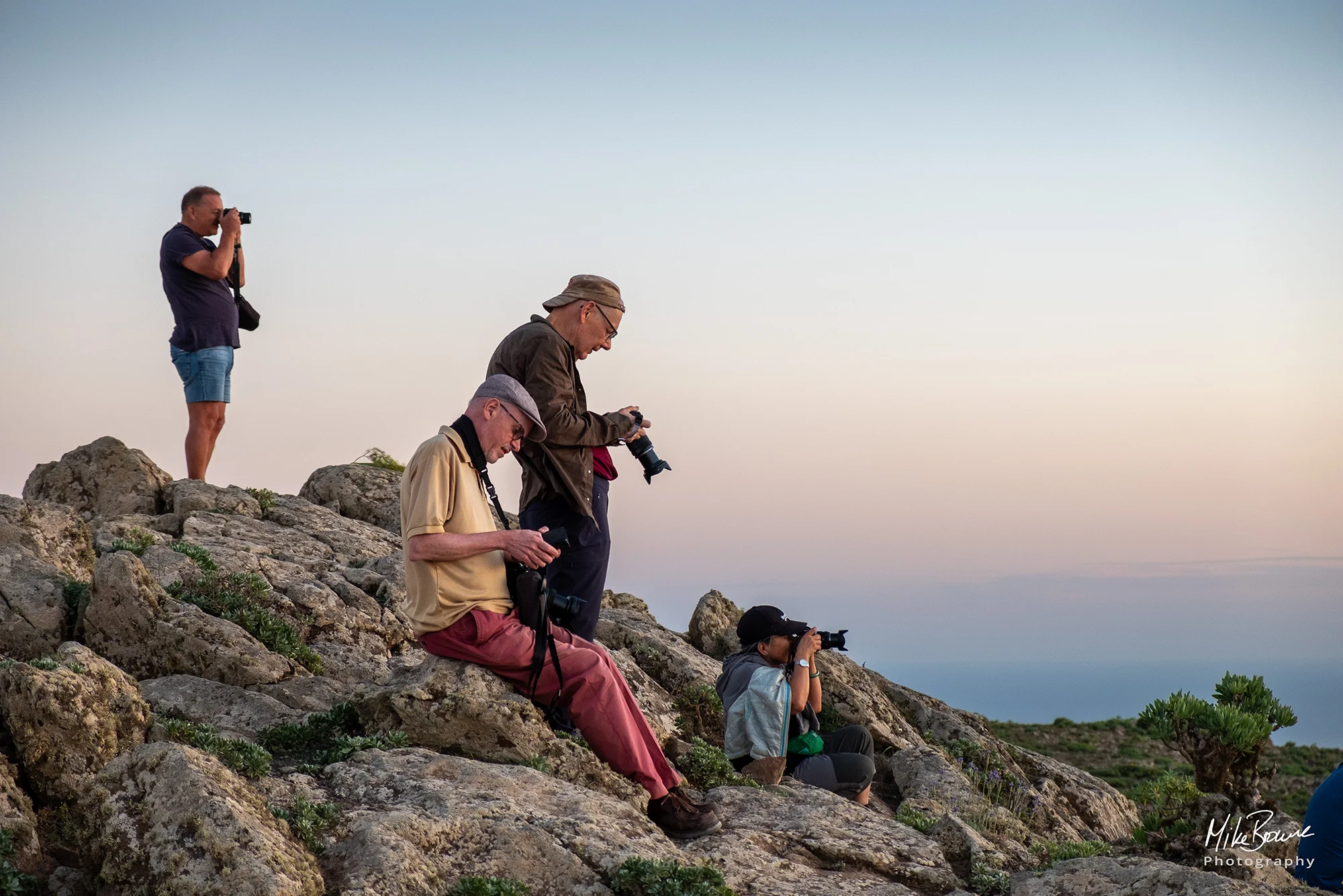 Photographers taking pictures and checking their cameras on a mountainside on Lanzarote