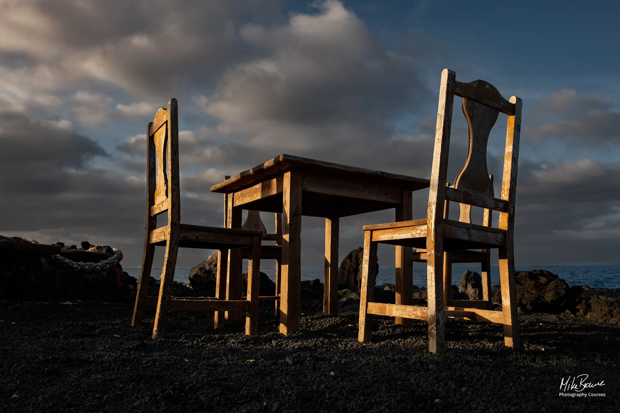 Outdoor table and chairs and cloudy sky by the sea in Tenesar, Lanzarote