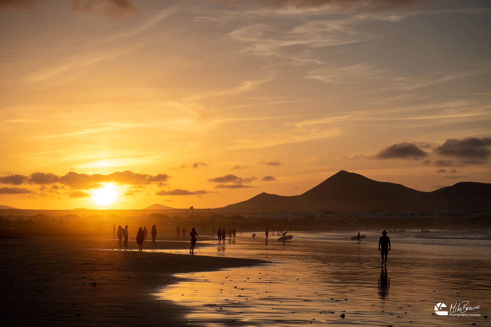 Sunset reflected on wet sand at Famara Beach, Lanzarote