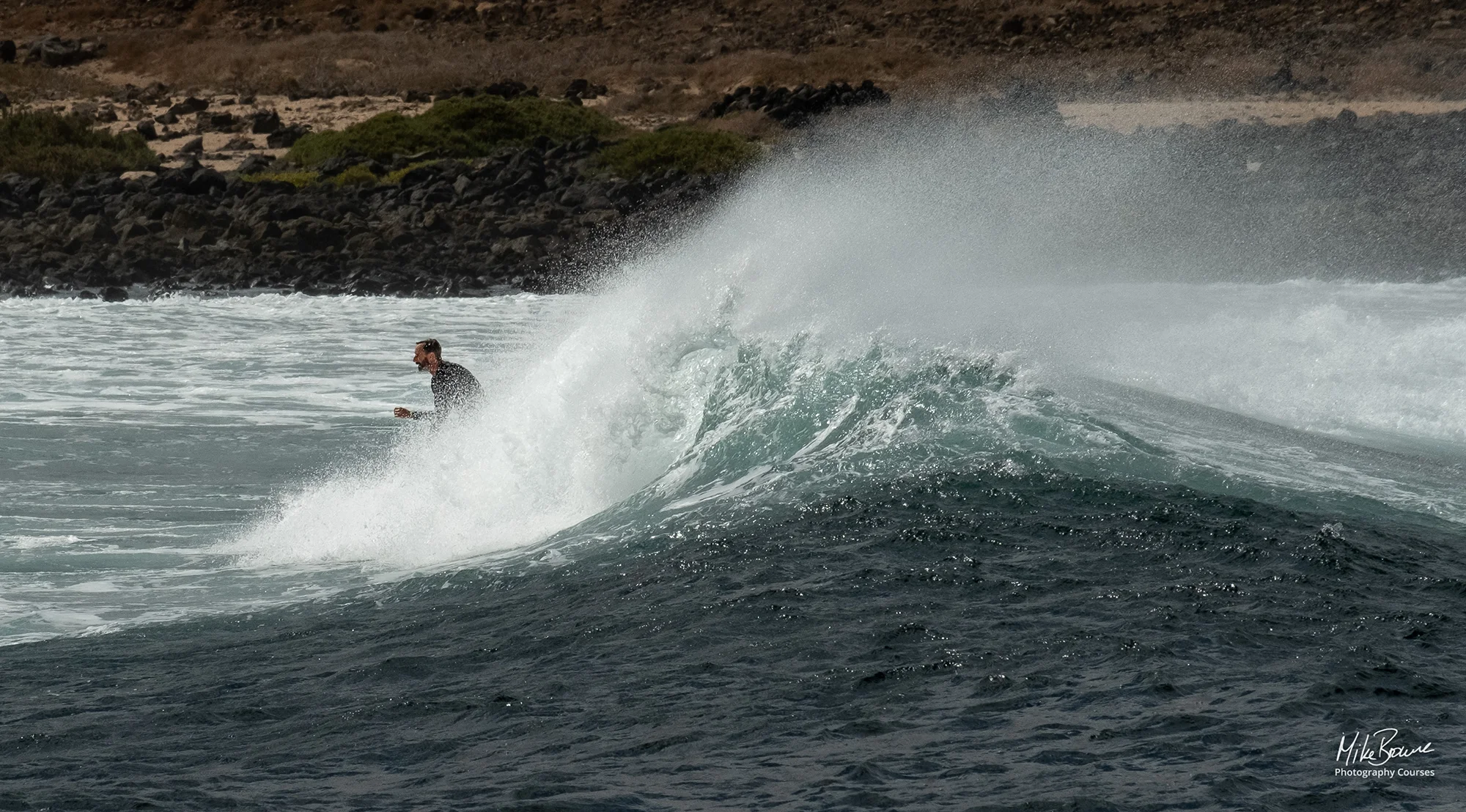 Surfer riding a wave at Playa de La Isleta, Lanzarote
