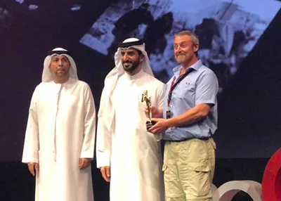 Mike Browne receiving award from deputy ruler of Sharjah UAE at Xposure
