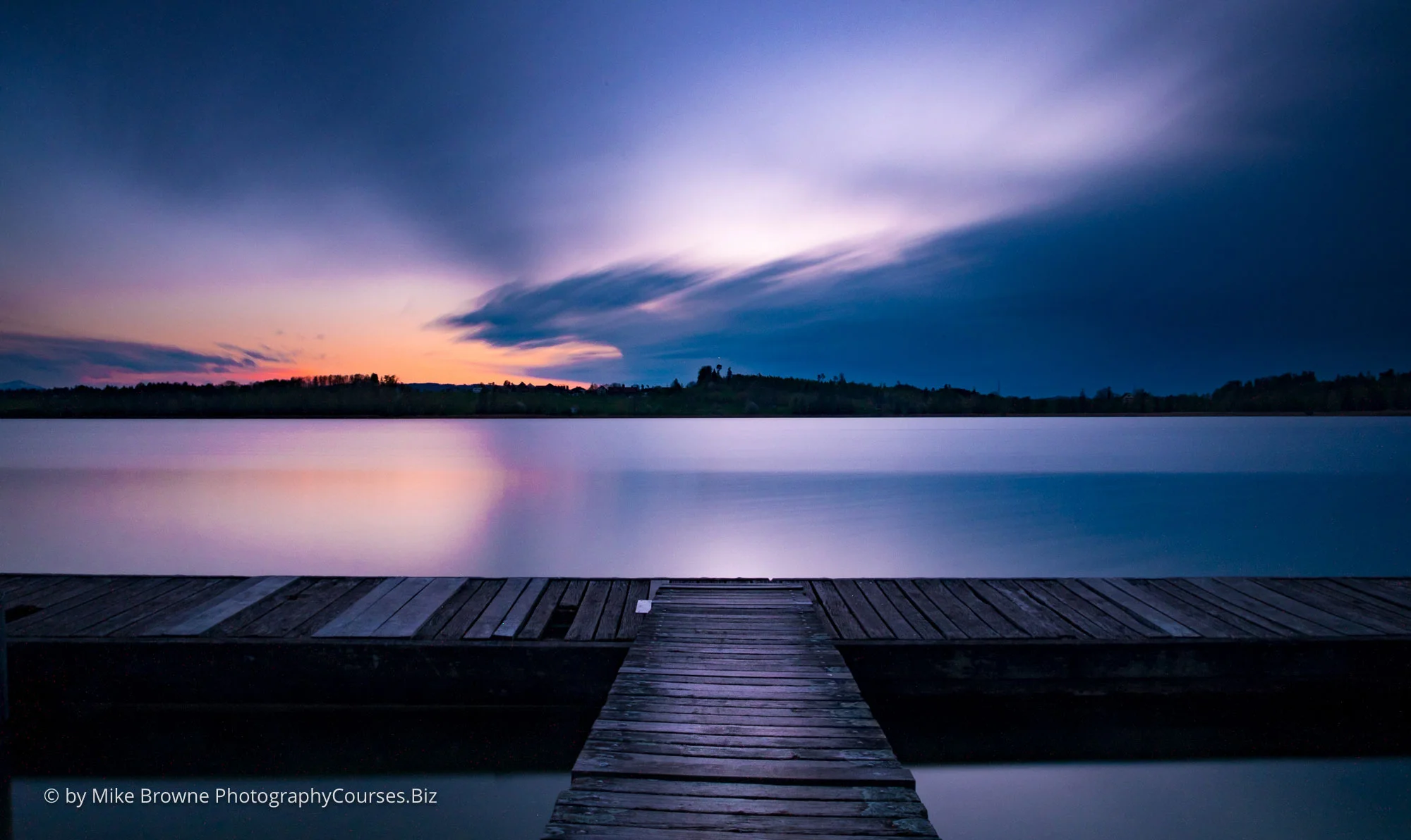Wooden dock and dramatic sky