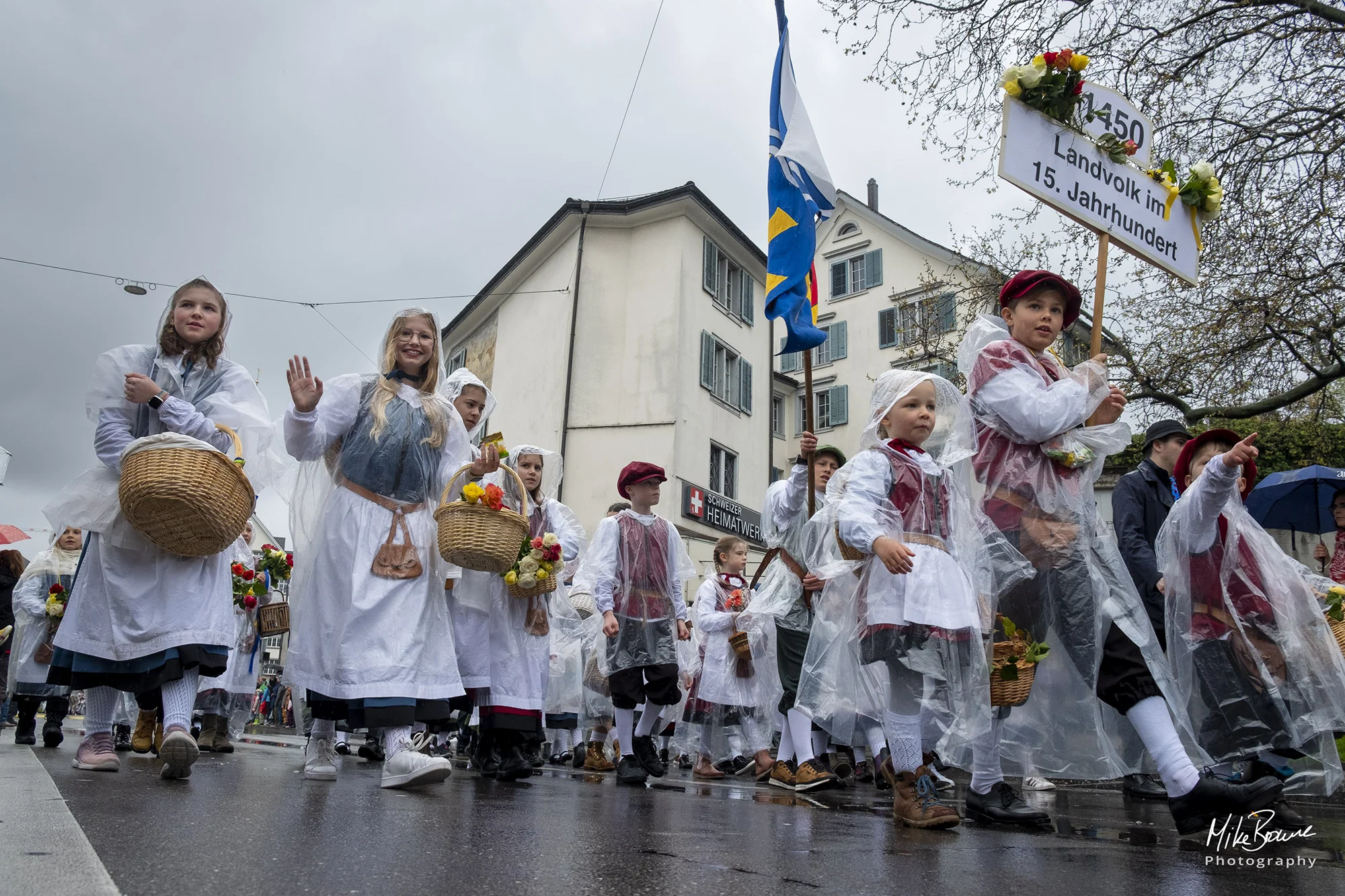 Female child waving at camera during Sechseläuten parade