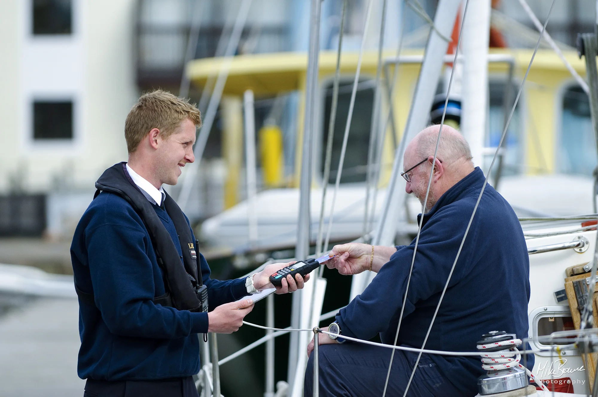 Yachtsman making a card payment to the harbourmaster