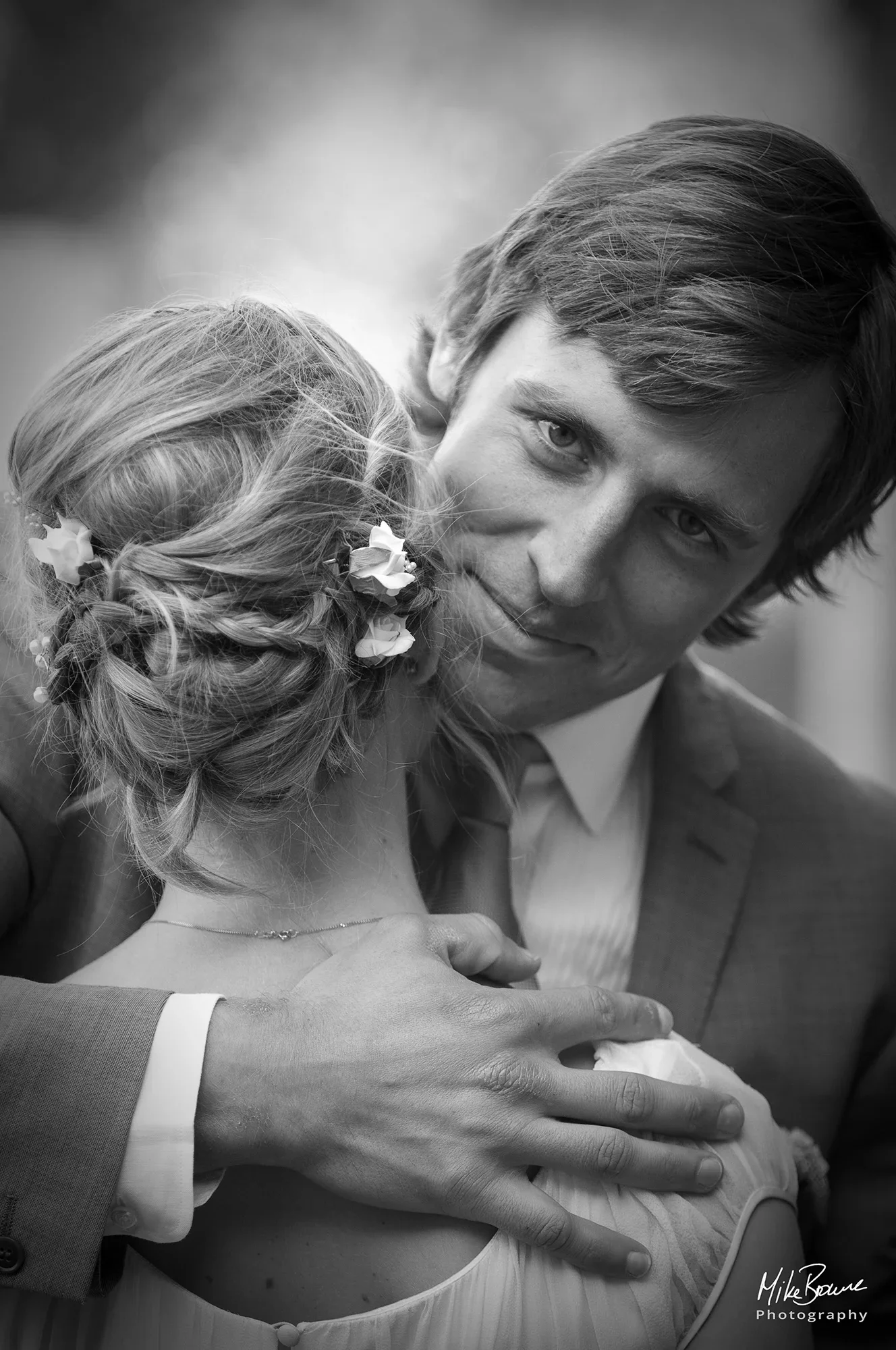 Man with proud expression has his arm around his new wife