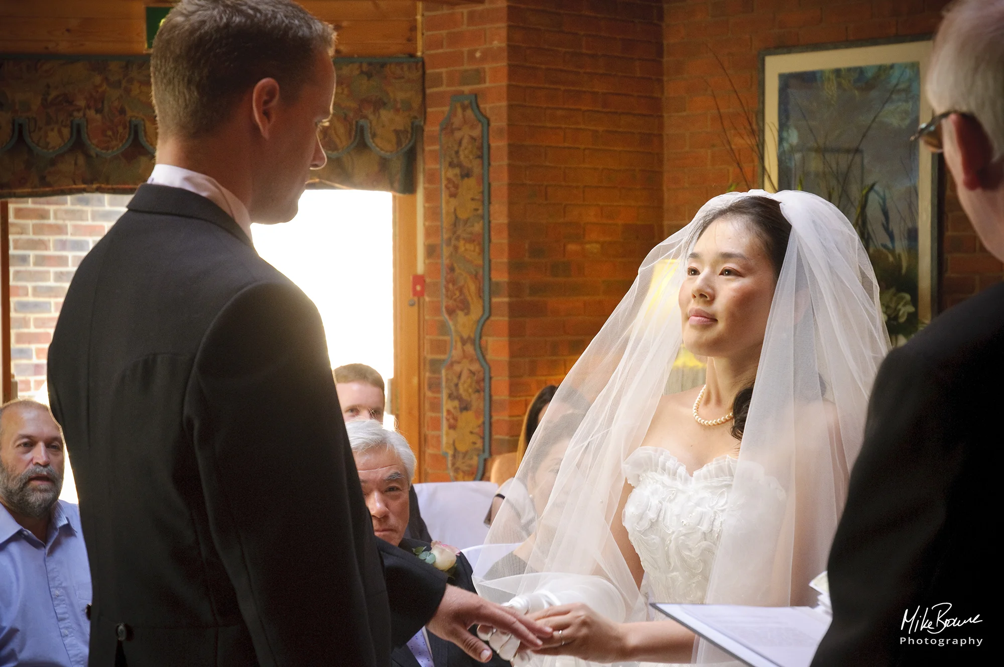 Bride looking at groom as they exchange rings and wedding vows