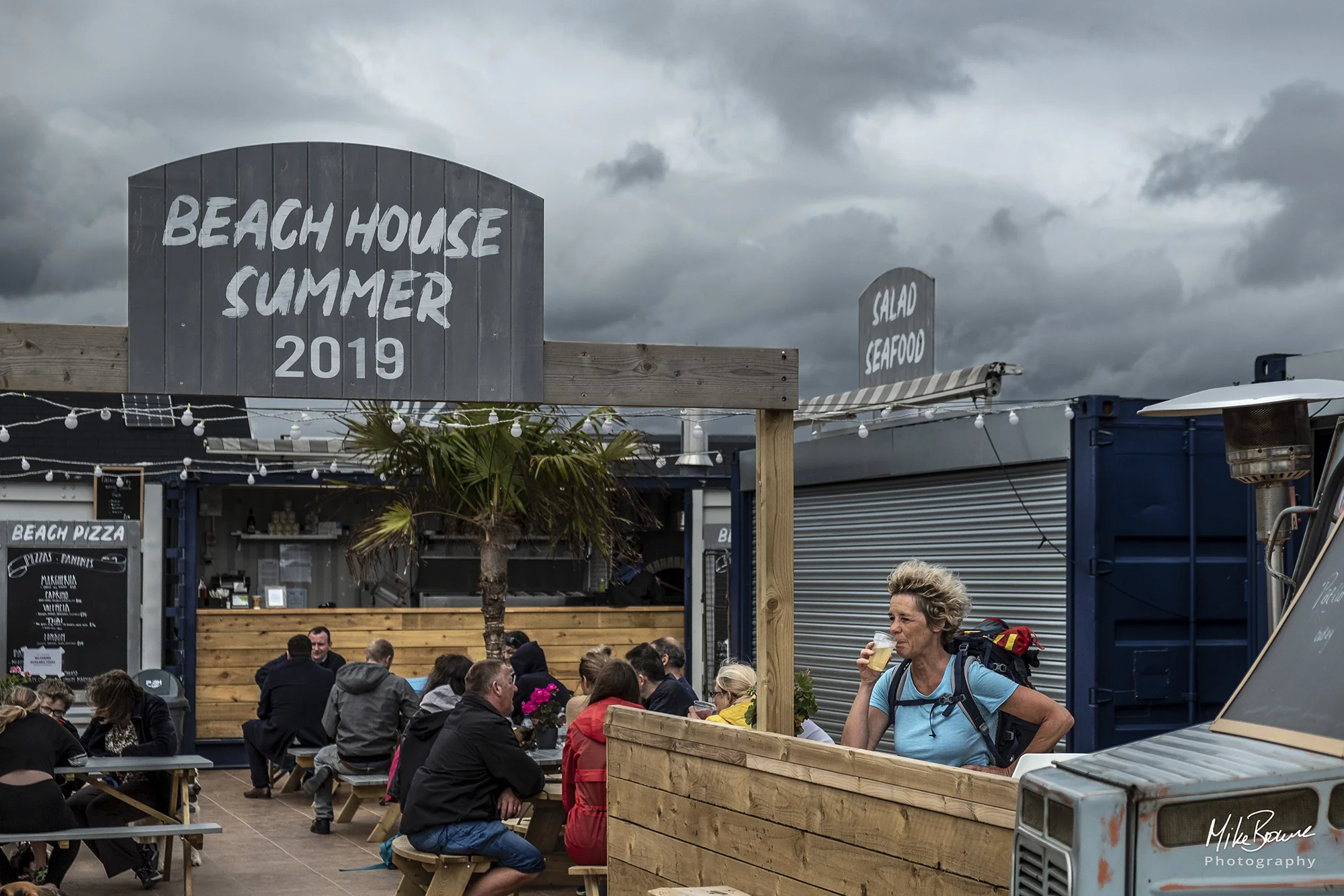 People at a British beach bar on a cloudy windy day