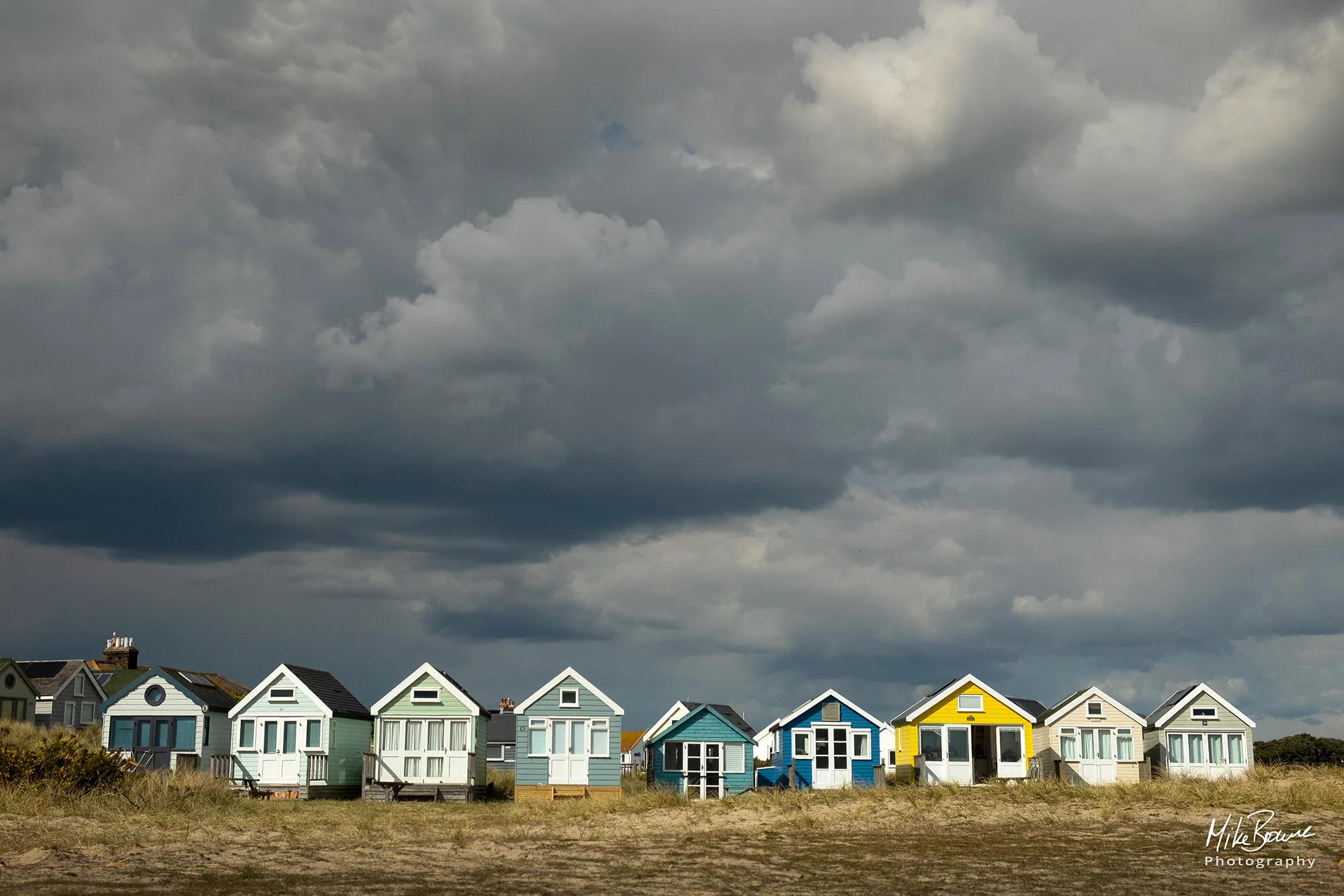 Colourful beach huts in sunshine