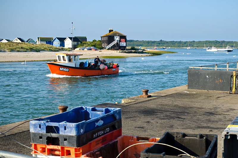 Red ferry at Mudeford crossing towards Hengistbury spit dock