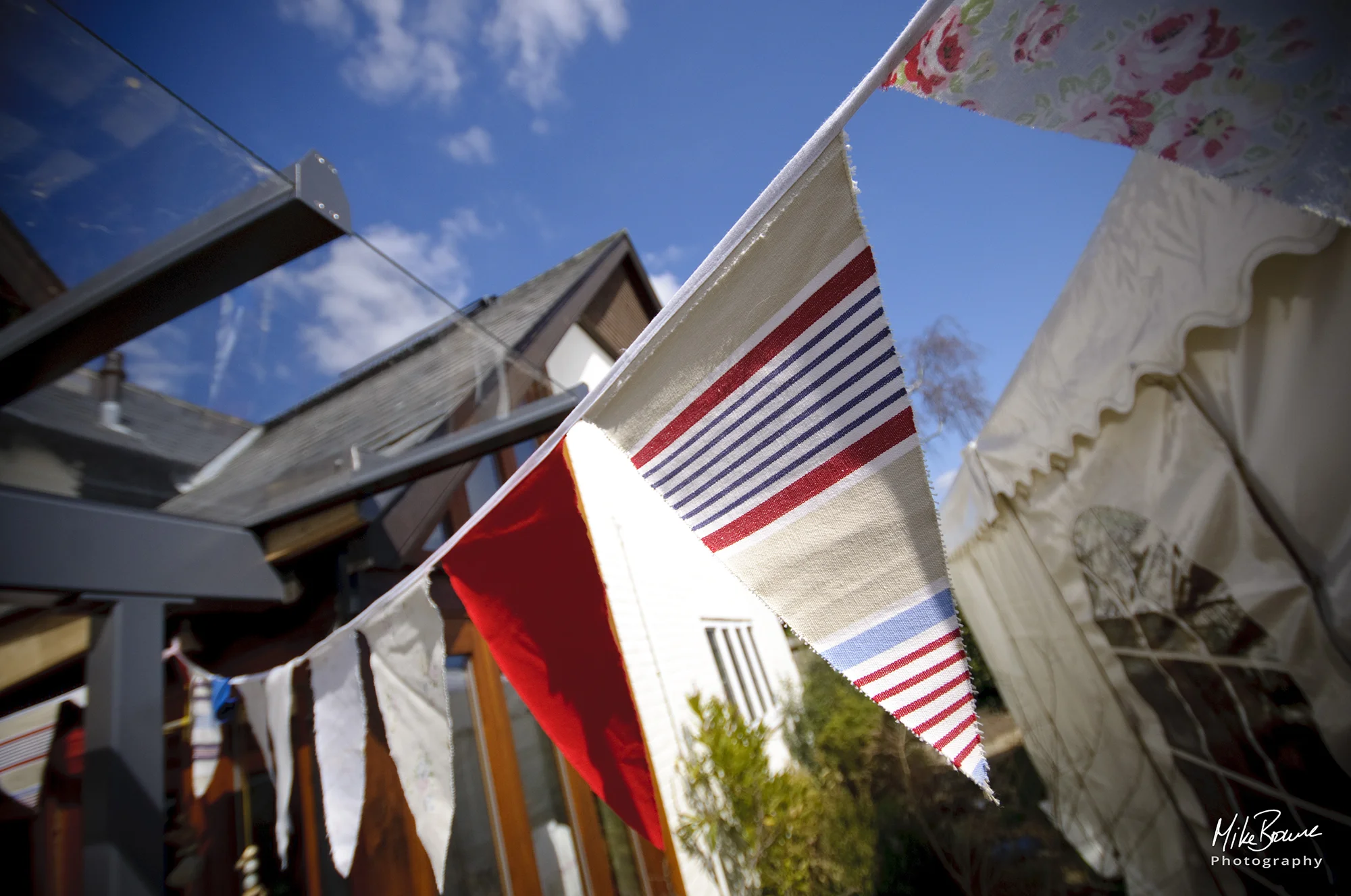 colourful triangular flags next to a white marquee