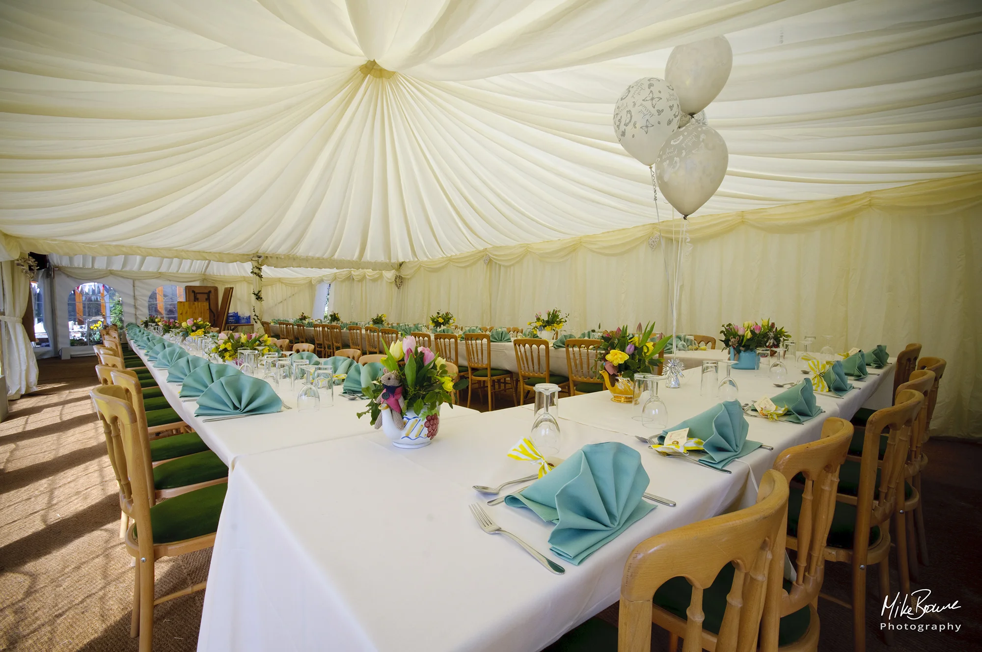 Place settings, flowers and balloons prior to a wedding