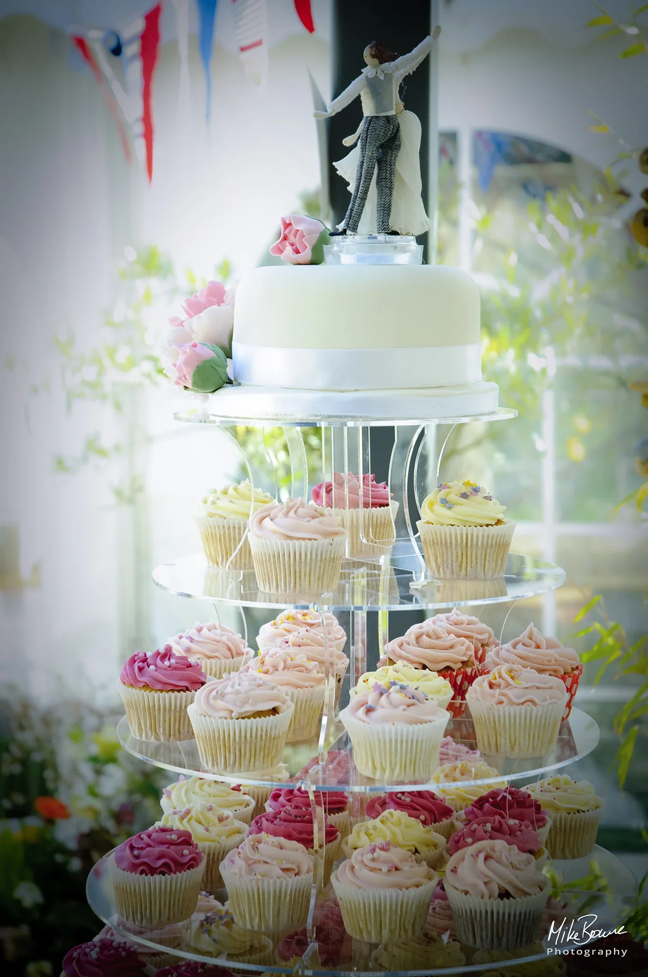 wedding cake display with miniature bride and groom dancing on top
