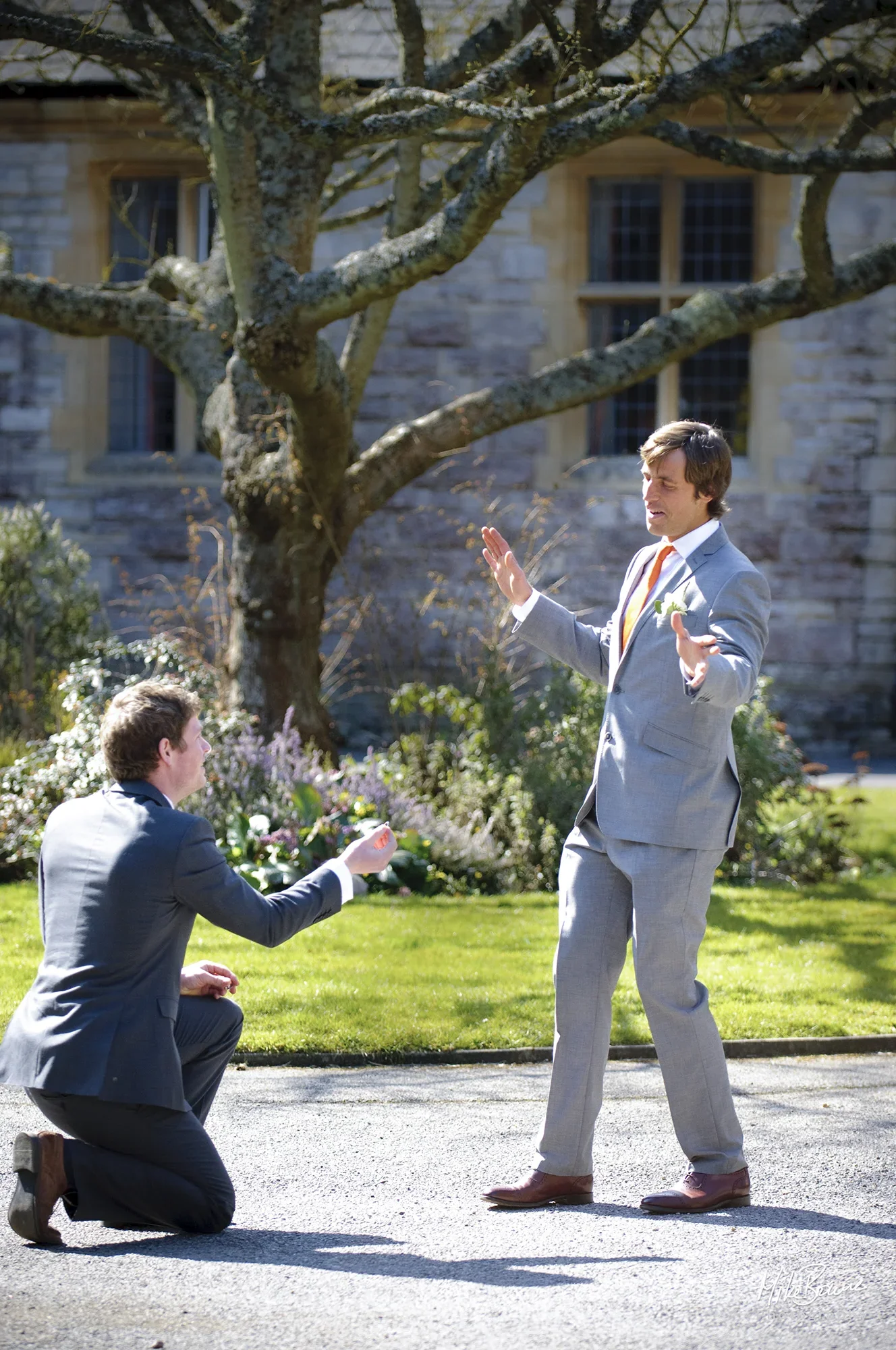 Bridegroom pretending to refuse best man in front of a church