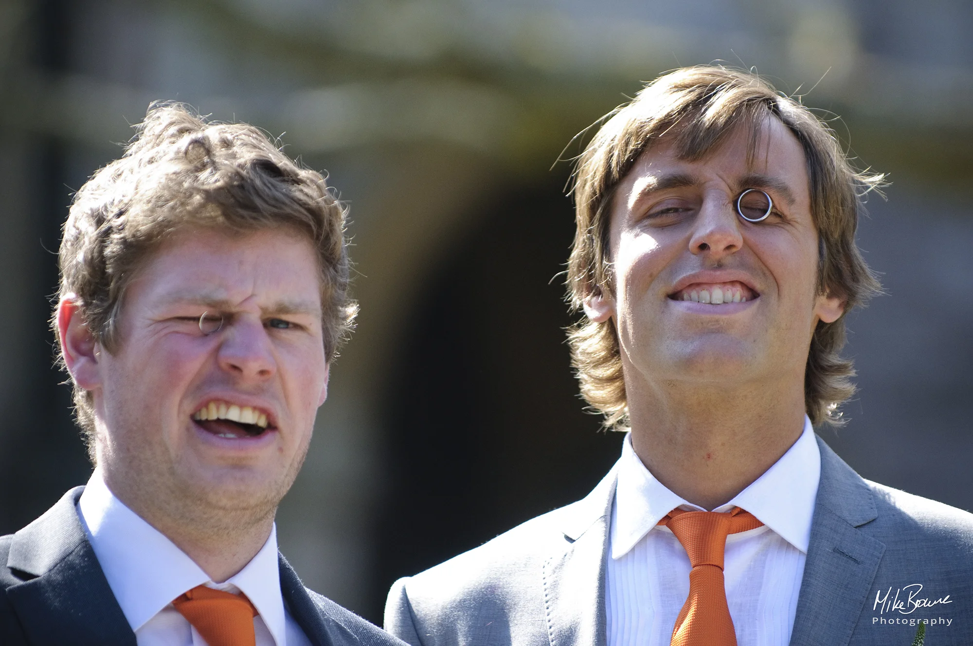 Man about to be married and his best man wearing the wedding rings as monocles