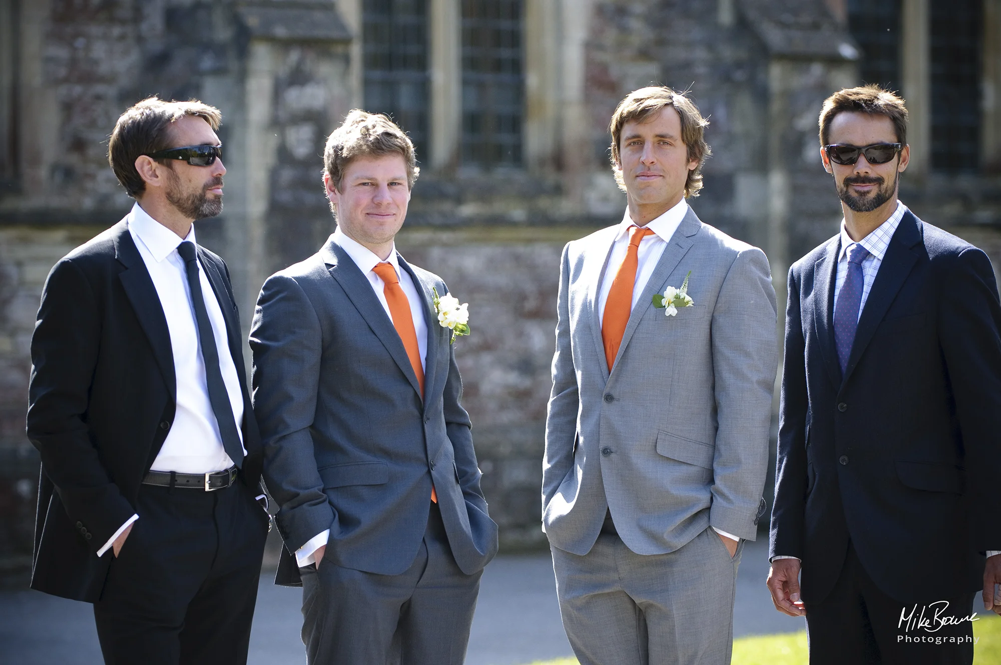 Groom and his attendants standing in front of the church