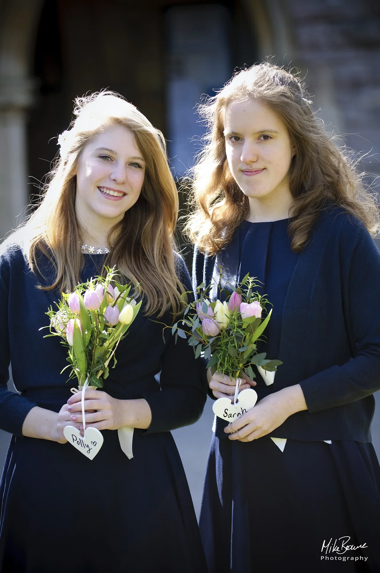 two young bridesmaids and their flowers