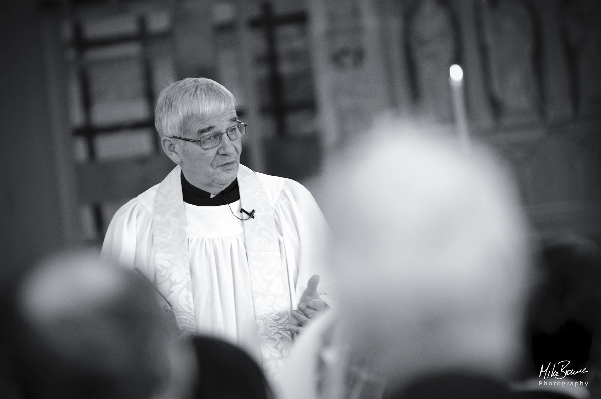 Vicar speaks to friends and family congregation during a wedding