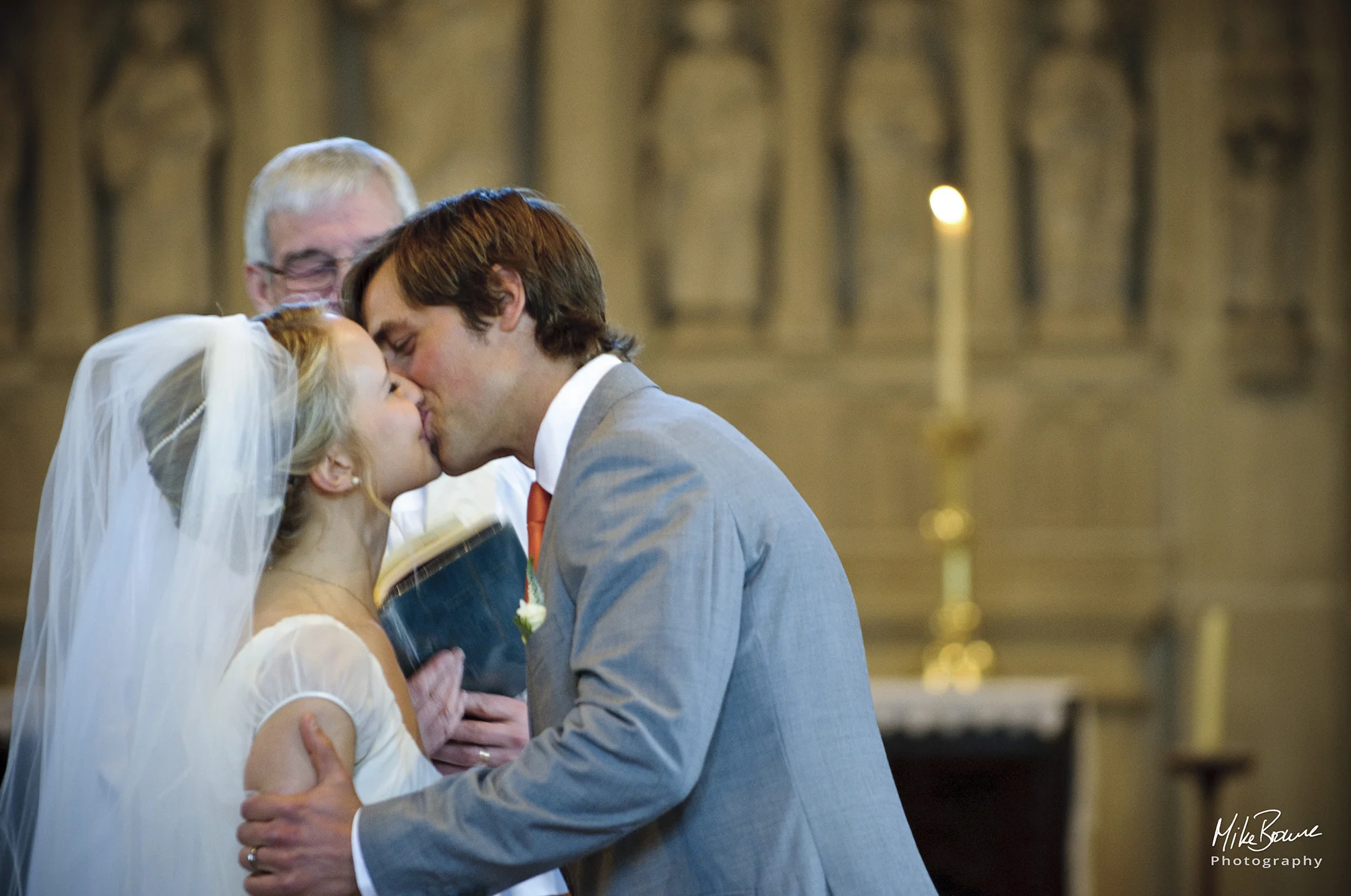 Newly married couple kiss during the service