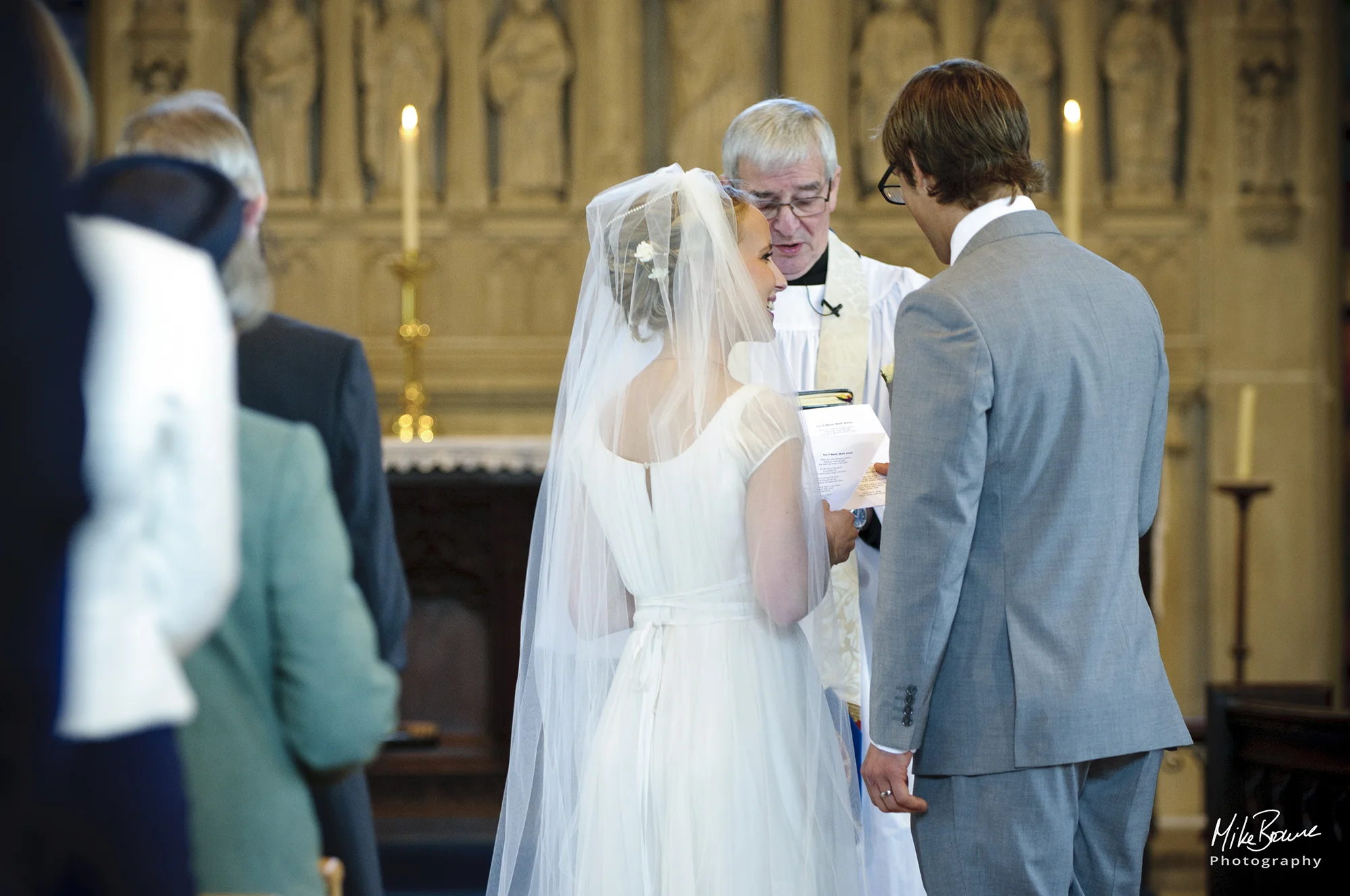 Bride cannot take her eyes off her new husband whilst singing a hymn at their wedding